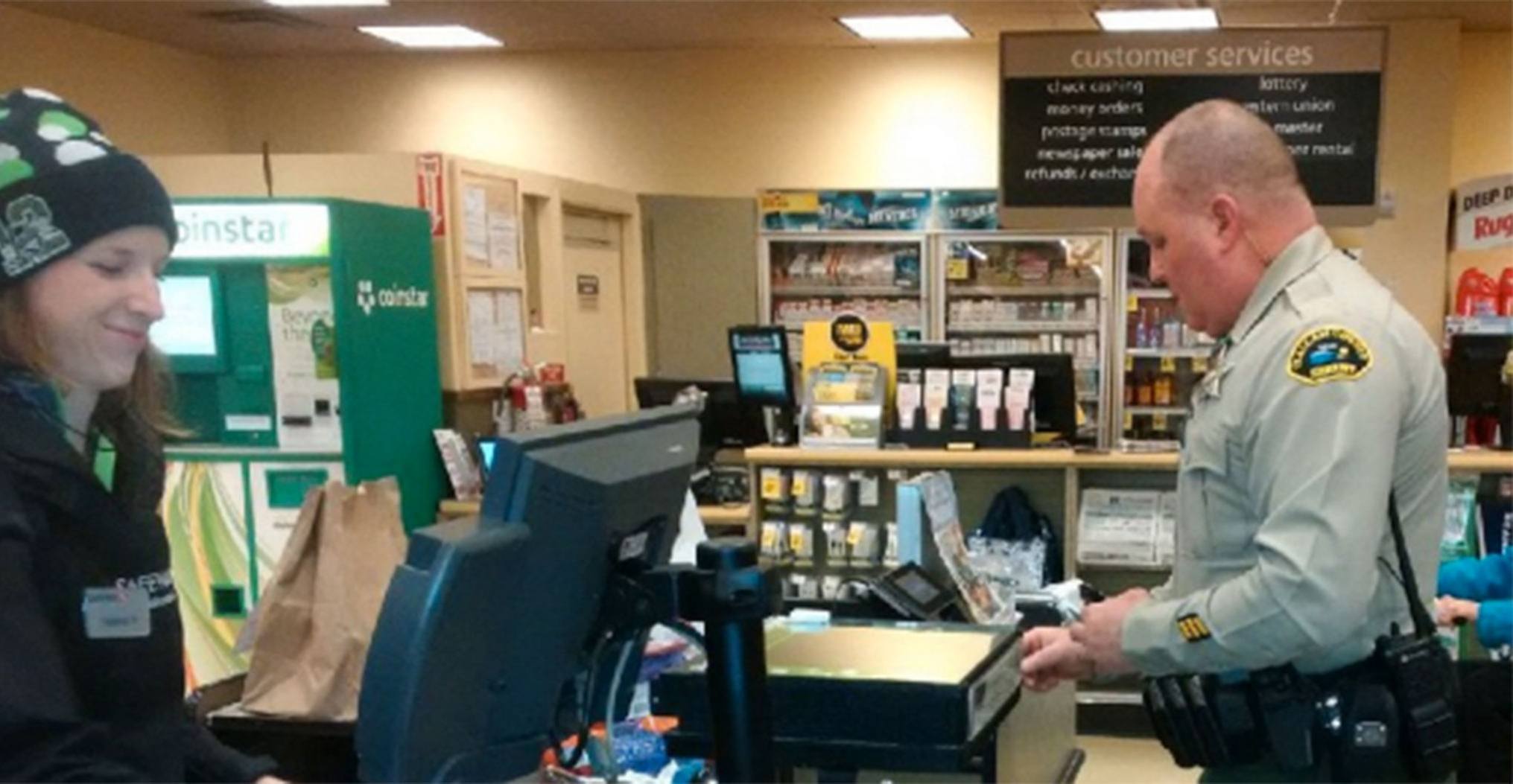 Clallam County Sheriff’s Deputy Don Kitchen buys some groceries for an Army veteran after encountering the man during an “erratic driver” call in the Sequim area.                                Photo courtesy Clallam County Sheriff’s Office