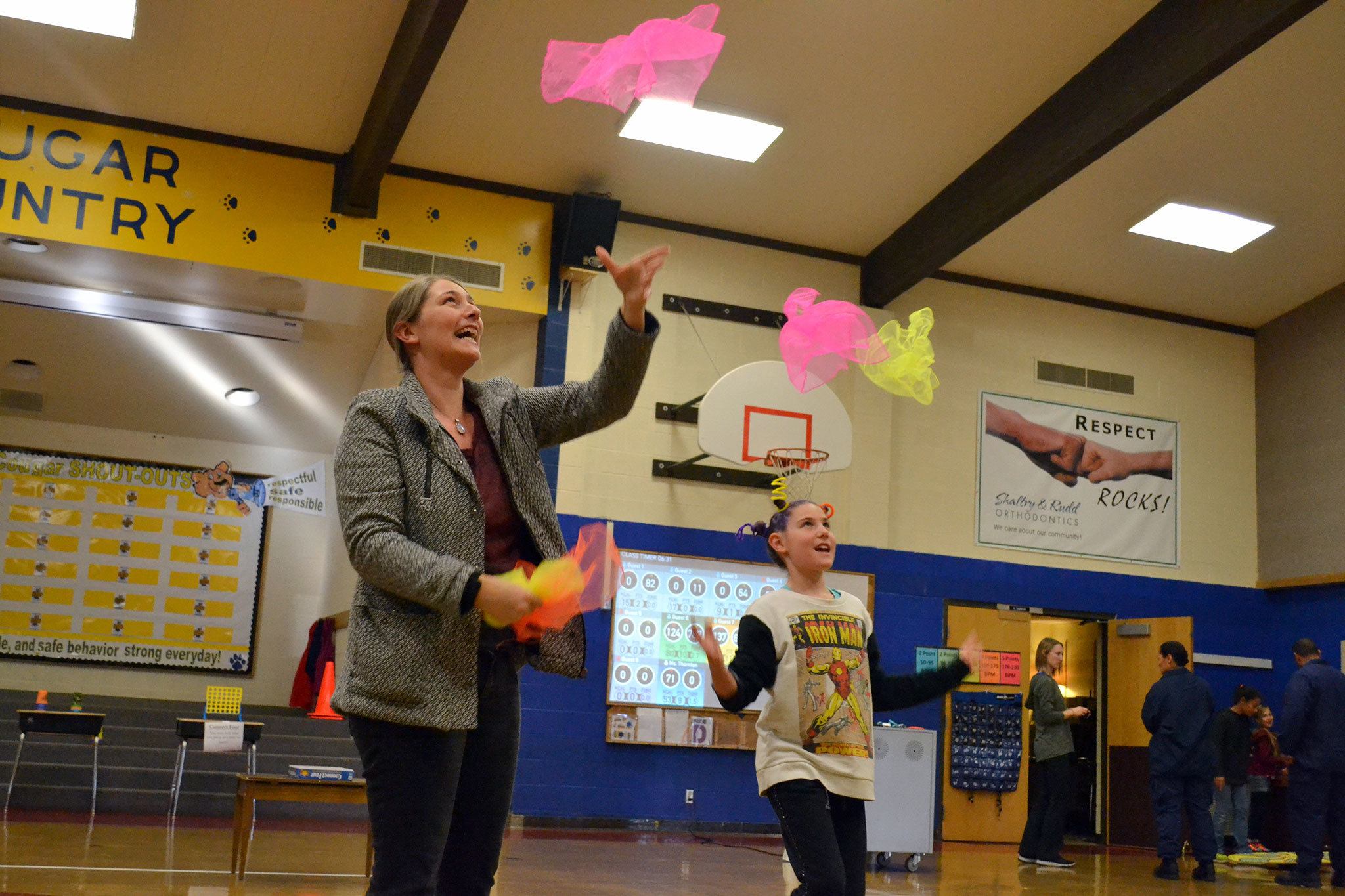 Allie Rush, 9, a fourth-grader, juggles with her mom Melissa Gatchet during conferences at Helen Haller Elementary to demonstrate how the Heart Tech Plus program works. It’s one of the programs the school’s PTO is raising funds for at the Turkey Trot. Sequim Gazette photo by Matthew Nash