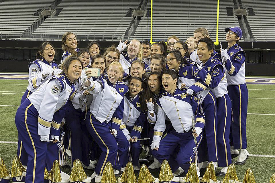 Sequim High grads Sarah Doty (middle row, third from left) and Mikaele Baker (back row, far right) join their fellow UW Marching Band piccolo players for a “selfie.” Submitted photo