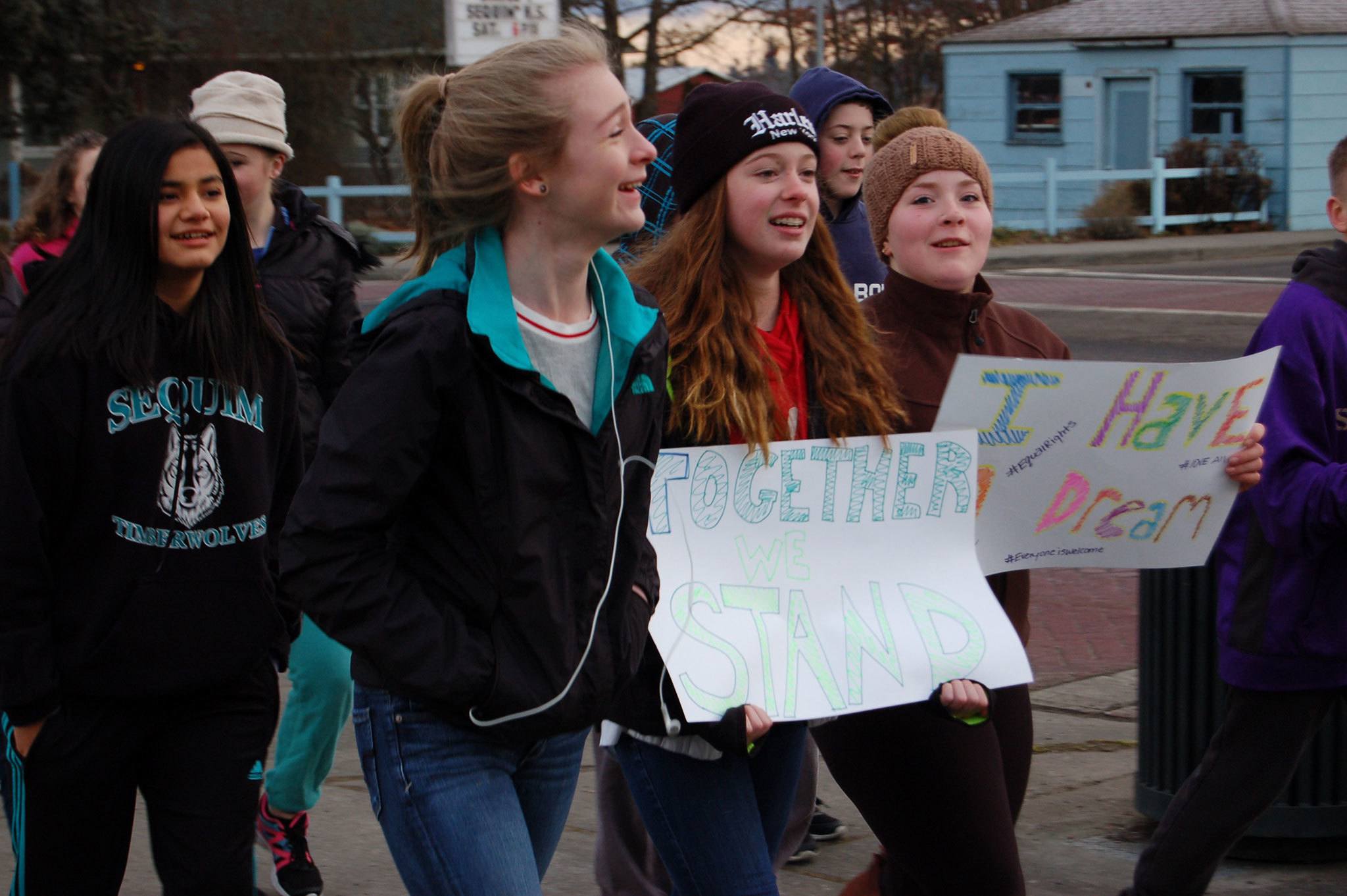 Eighth-graders Olivia Preston (right) and Mary Mcaller (center) held signs for Martin Luther King Jr. Day during the Sequim Middle School Martin Luther King Day Jr. walk accompanied by Maya Reiter (left). Sequim Gazette photo by Erin Hawkins
