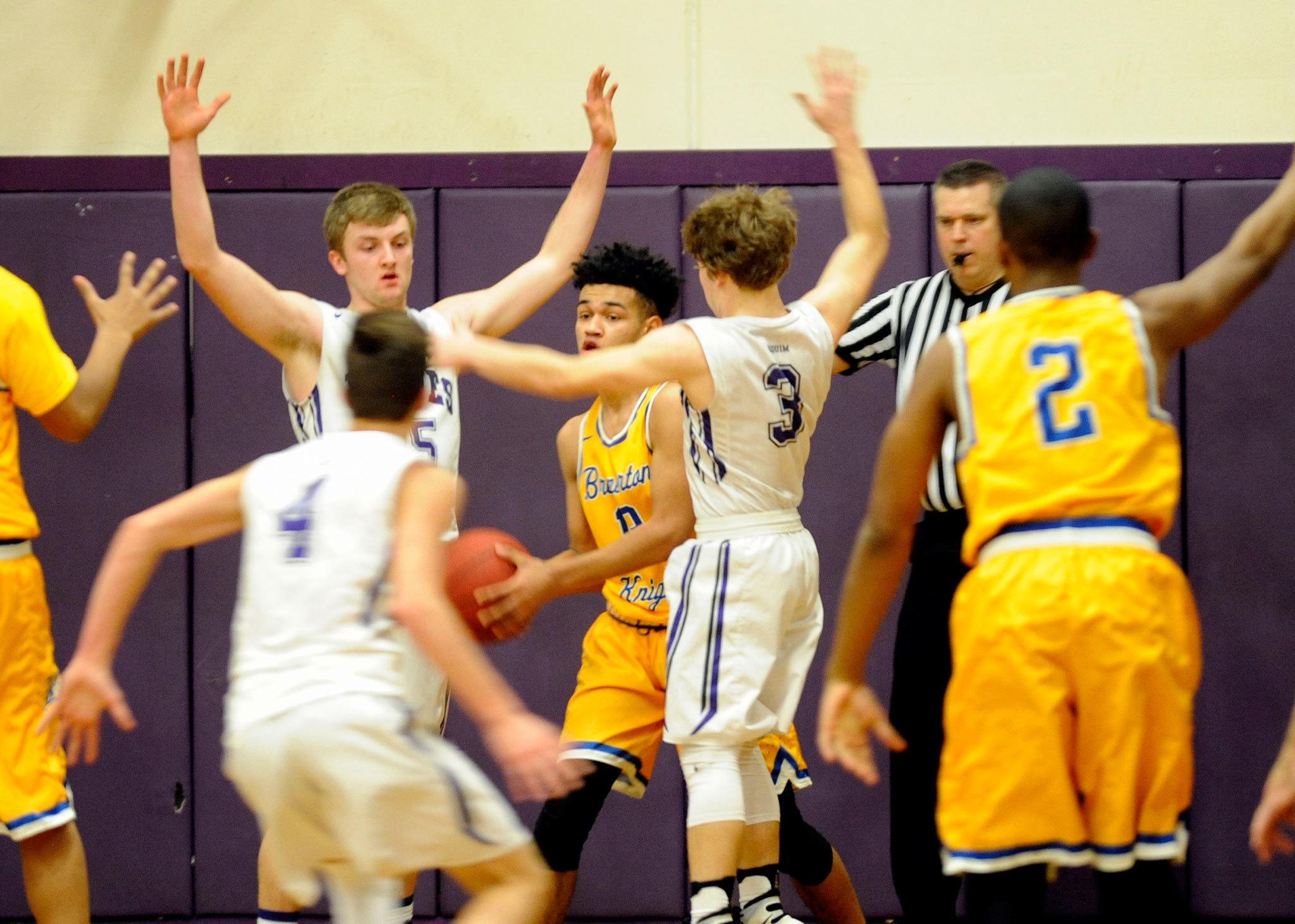 Bremerton’s Domonic Baker is swarmed by Sequim’s Nate Despain, Riley Cowan and Kyler Rollness in a late-game moment on Jan. 13, in Sequim. Bremerton went on to win 52-42. Sequim Gazette photos by Matthew Nash