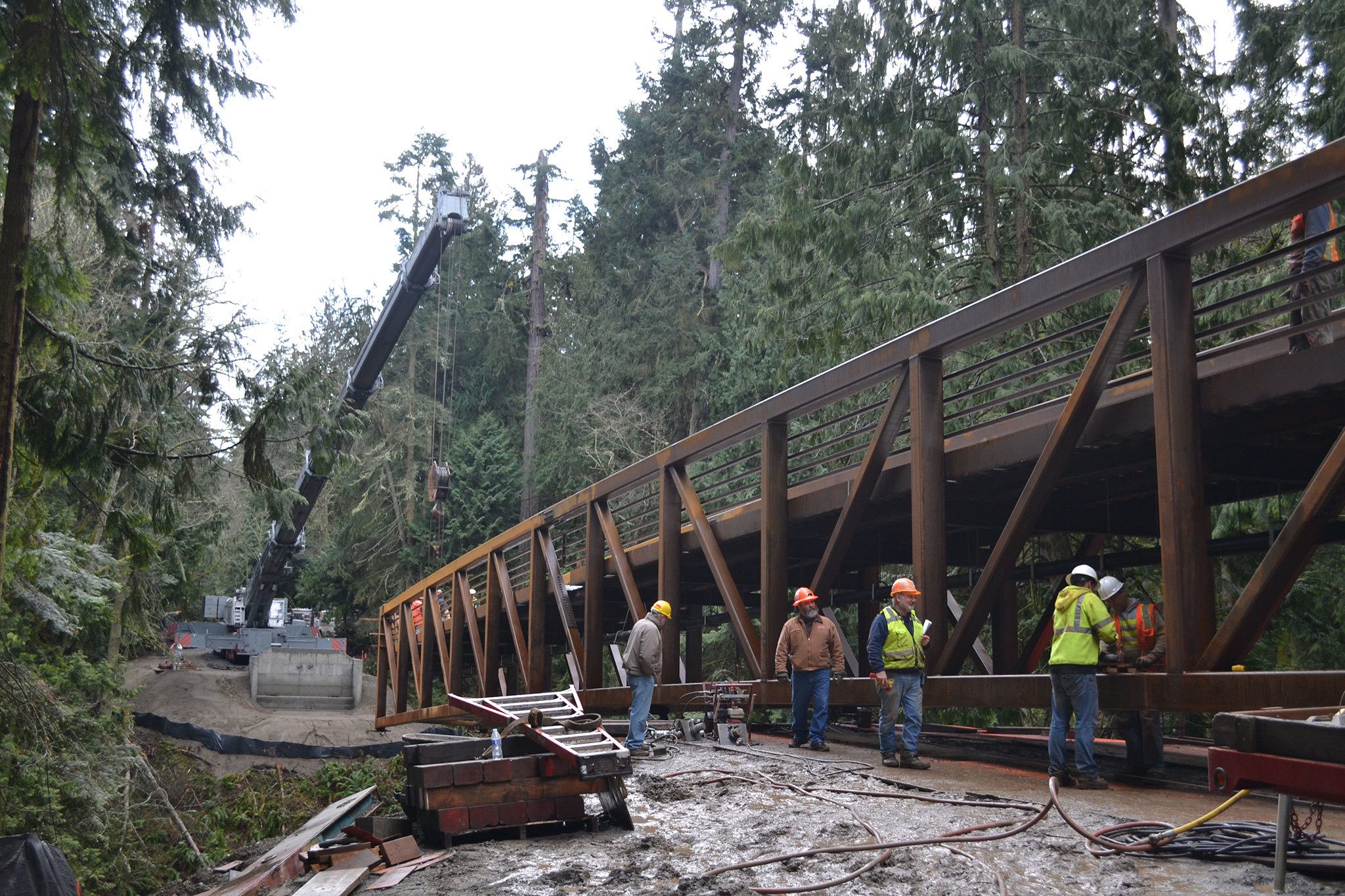Crews continue work on placing a new bridge in Sequim Bay State Park on Jan. 19. The installation follows a federal injunction to remove culverts that obstruct salmon migration. Sequim Gazette photo by Matthew Nash