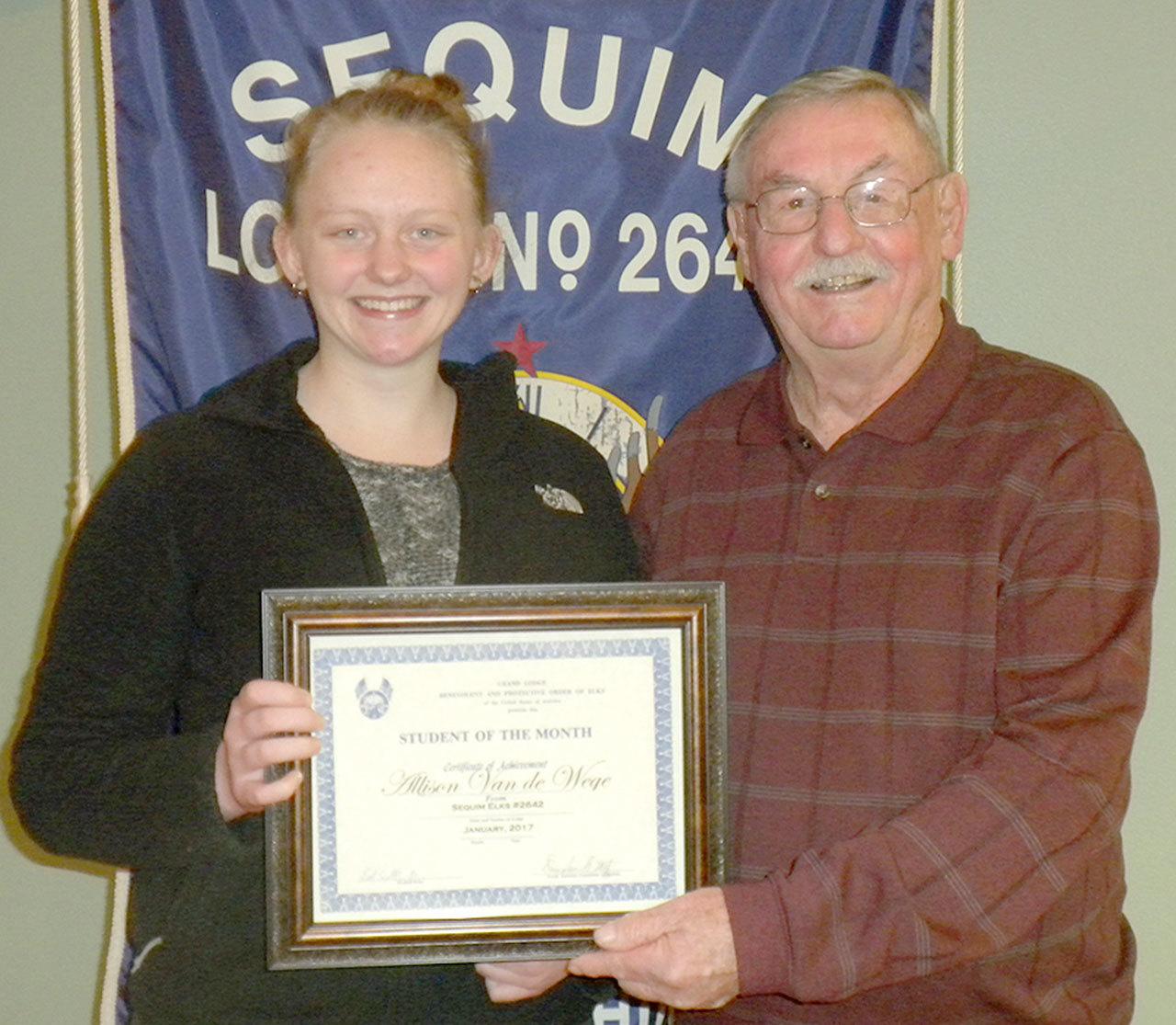 Allison Van De Wege, a 3.9 GPA Sequim High School sophomore, 
was named Student of the Month by the Sequim Elks Lodge at its January social night dinner.                                 She was selected for her high academic achievements and student involvement at SHS. Her current class schedule includes Algebra 2, ceramics, photography, Spanish 2, chemistry and World Literature. Her interests are cooking, hiking and being around people. She is also involved in Leadership Class, dance and Aspire, volunteering at the Sequim Food Bank, FBLA and Be the Change Club. Her future plans are to attend college on the West Coast and major in elementary education. She is the daughter of Kevin and Jennifer Van De Wege.                                 Pictured are Van De Wege and Doug Metz of the Sequim Elks Lodge.