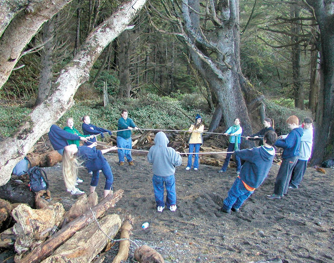 Eighth-graders from the YMCA TEAM Program participate in a trust circle during a weekend retreat in 2003. Submitted photo
