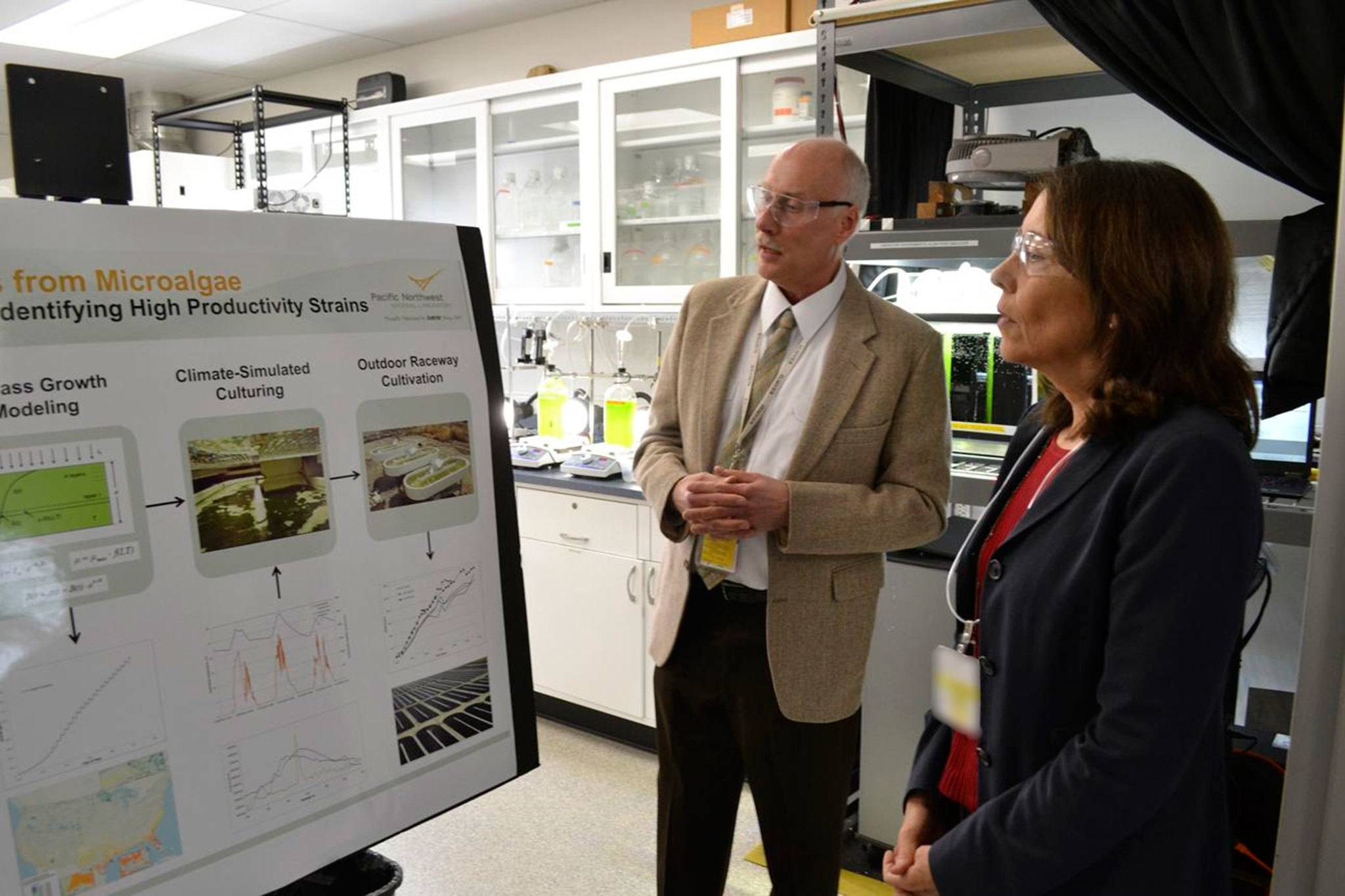 Dr. Michael Huesemann, lead researcher for the algae biofuel program in Sequim’s Pacific Northwest National Laboratory, meets with U.S. Sen. Maria Cantwell briefly in July 2016 about algae and its potential. His current project looks to find the best growing conditions for algae to harvest biofuel quickly. Sequim Gazette file photo by Matthew Nash