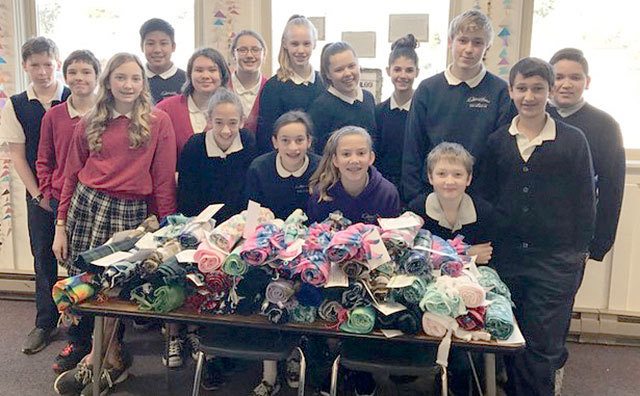Milestone: Queen of Angels School students give scarves, cards