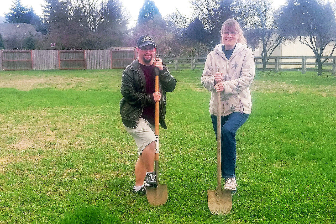 Michael Rief and Ursula Schletter break ground on the first house in Sequim for Olympic Peninsula Special Needs Housing. Photo by Tom Rief