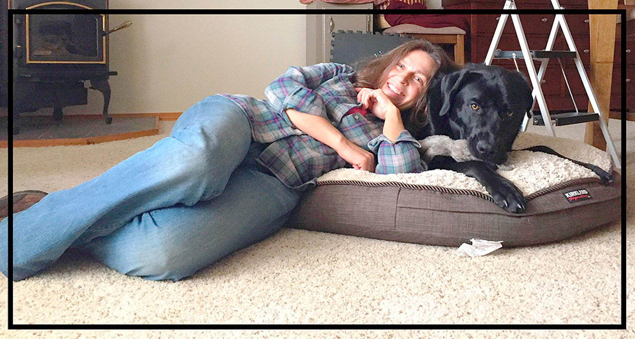 Professional pet sitter Connie Wetzler lounges with her charge Brodie, a mastiff/lab/husky mix. Submitted photo