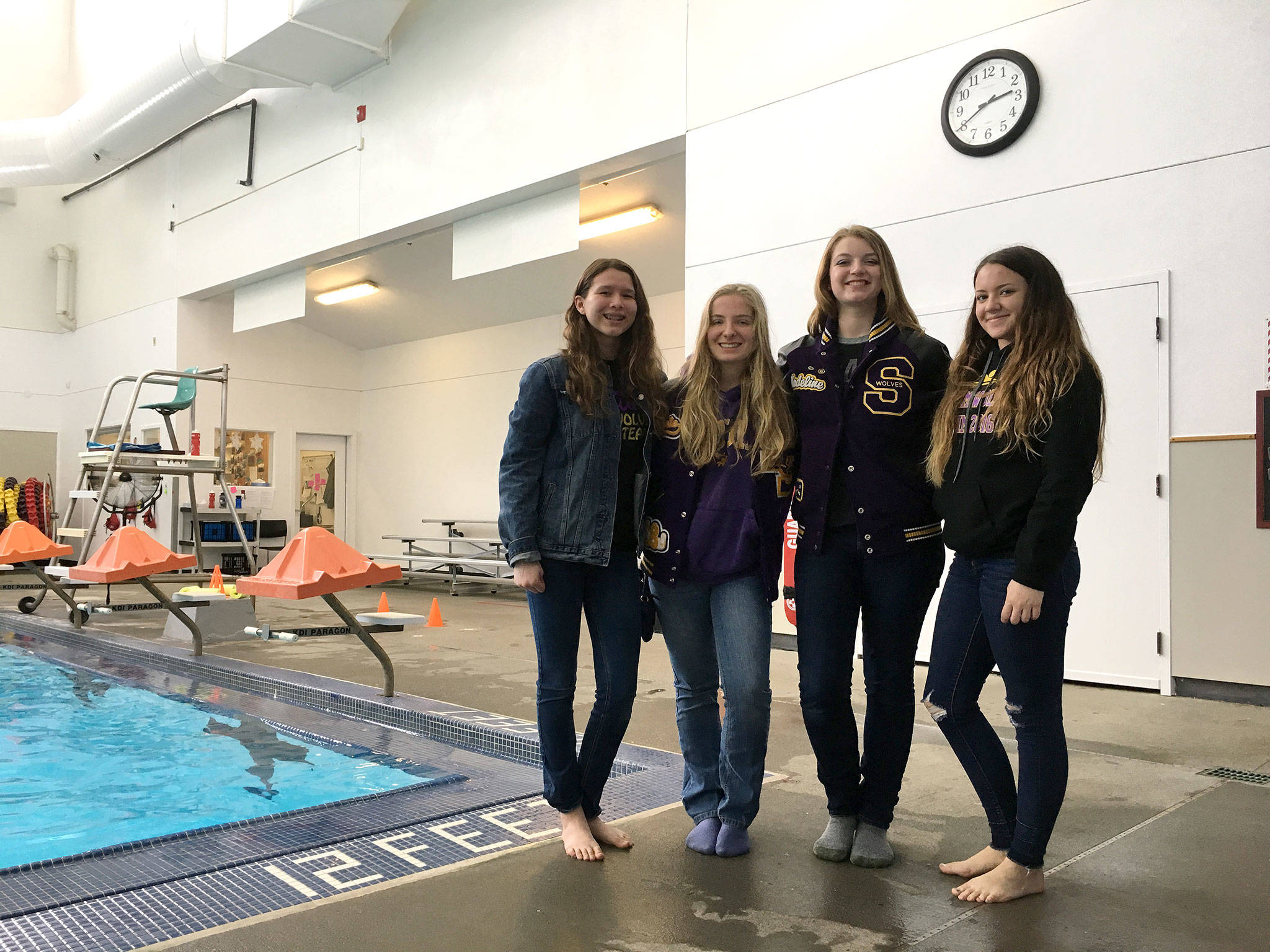 Sequim High School girls swim team members, from left, Sonja Govertsen, Annie Armstrong, Madeline Patterson and Sydney Swanson, continue to help with an effort to install underwater touch pads and a scoreboard in the Sequim YMCA for its many teams. They set a $25,000 goal for mid-August through a GoFundMe online fundraiser and various fundraisers in the months to come. Sequim Gazette photo by Matthew Nash