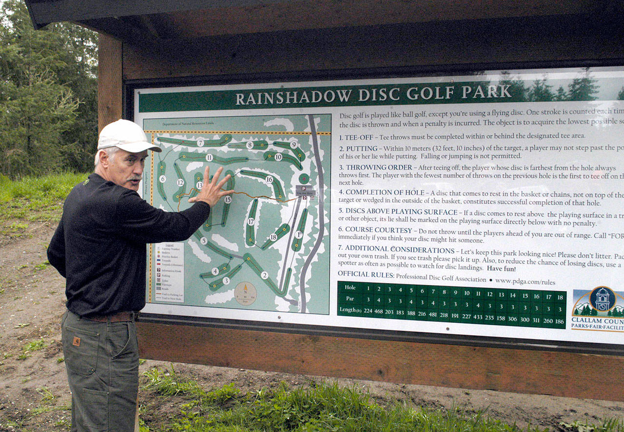 Clallam County Parks Board and Port Angeles Disc Golf Association member Roger Hoffman explains the layout of the Rainshadow Disc Golf Course to Clallam County parks tour attendees Wednesday. Hoffman designed the 18-hole disc golf course northeast of Blyn, which is set to open in the early summer. (Rob Ollikainen/Peninsula Daily News)