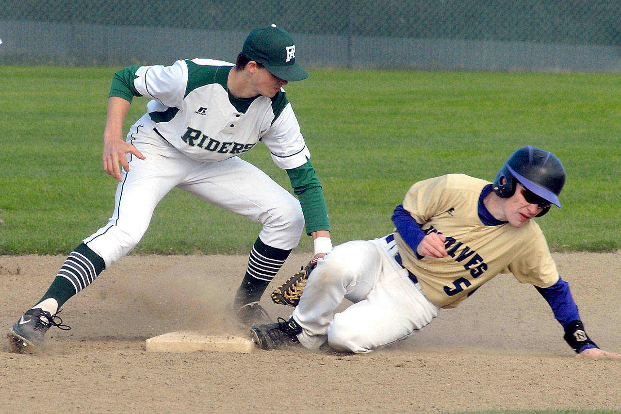 Port Angeles’ Colton McGuffey, left, cuts off a second base steal attempt by Sequim’s Justin Porter in the third inning on April 26 at Volunteer Field in Port Angeles. Photo by Keith Thorpe/Peninsula Daily News