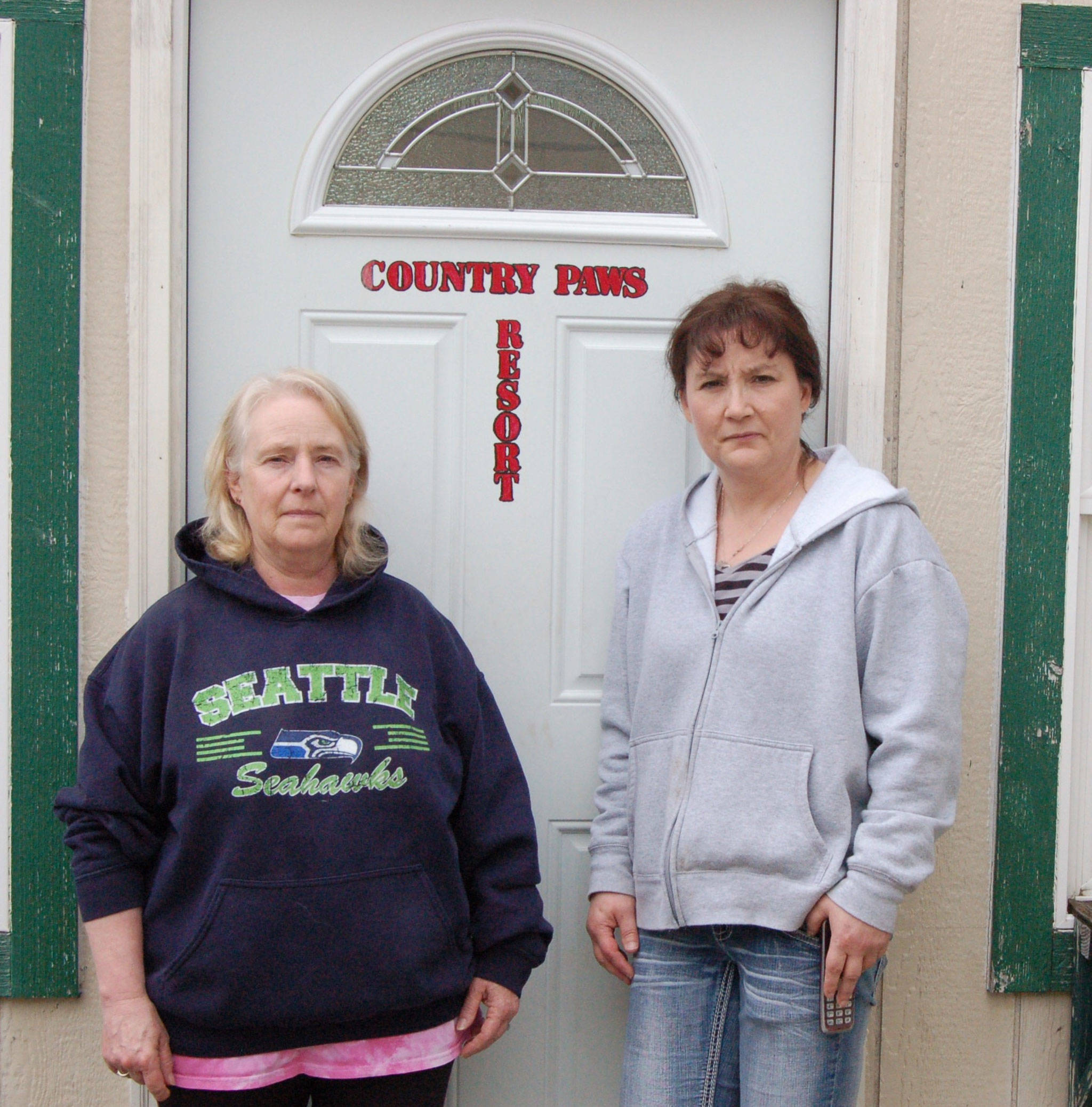 Country Paws Resort owner Shelley Denton, left, stands with employee Noelle Geyer, right, in front of their office building after discussing how the company was scammed from a private advertising company claiming to be through the Sequim-Dungeness Valley Chamber of Commerce. Sequim Gazette photo by Erin Hawkins