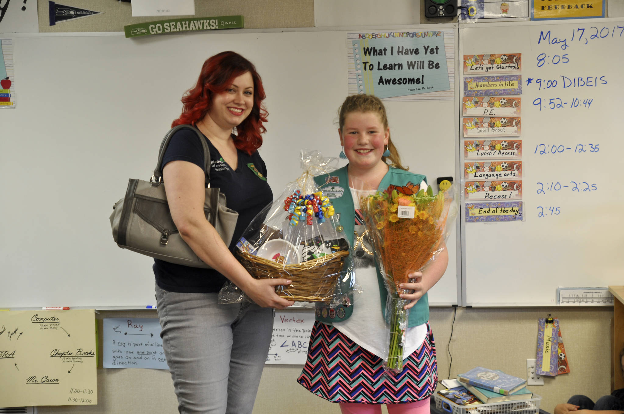 Laurel Arnau, product program manger for the Girl Scouts of the Olympic Peninsula, surprises Paige Krzyworz on May 17 in her fourth-grade classrom with news she is the highest selling Girl Scout cookie salesperson on the Olympic Peninsula and No. 2 in Western Washington. She’ll receive a ride in a limousine with the Girls Scouts of Western Washington’s CEO and a fancy dinner among many other goodies later this month for selling more than 3,000 boxes of cookies. Sequim Gazette photo by Matthew Nash