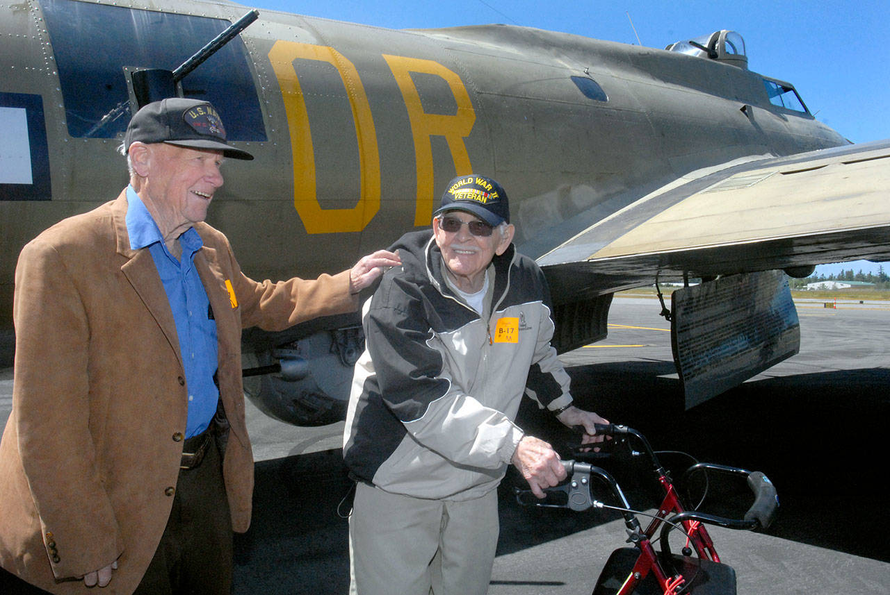 Veterans Frank Meek of the U.S. Navy and Don Alward of the U.S. Marine Corps show delight at the end of their flight aboard a restored B-17 bomber on Wednesday at William R. Fairchild International Airport in Port Angeles. Keith Thorpe/Peninsula Daily News