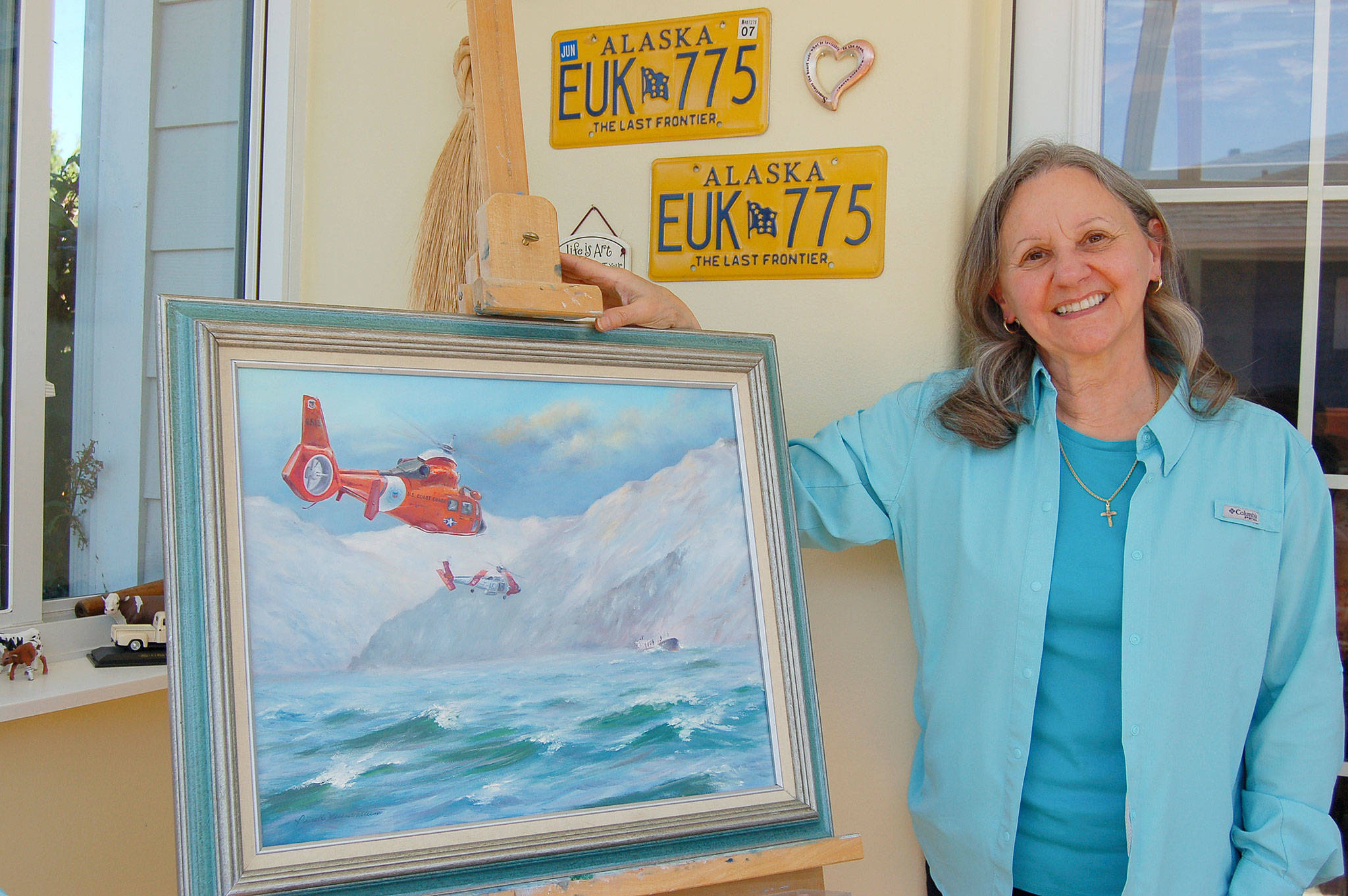 Sequim artist Priscilla Patterson stands next to her painting “Answering the Mayday” which will be featured in her upcoming solo exhibit at the Sequim Museum & Arts from July 5-Aug. 31. Sequim Gazette photo by Erin Hawkins
