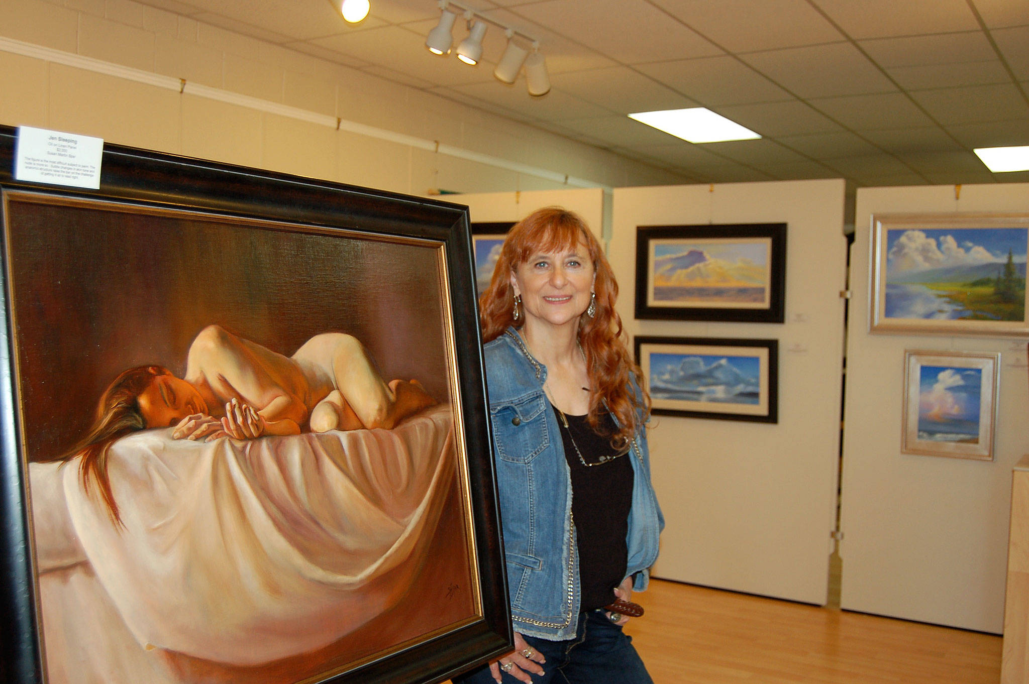 Local artist Susan Spar stands next to her exhibit centerpiece, “Jen Sleeping” on display at her show “People, Places & Things of the Heart” at the Sequim Museum & Arts Center. She will hold an artist demonstration and reception on Saturday, June 17, at the Sequim Museum & Arts Center. Sequim Gazette photo by Erin Hawkins