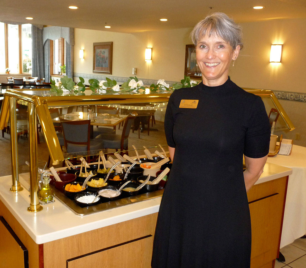 AJ Hitchcock, community relations director at The Fifth Avenue, invites the public to try what she terms “the best salad bar in Sequim.” Sequim Gazette photo by Patricia Morrison Coate