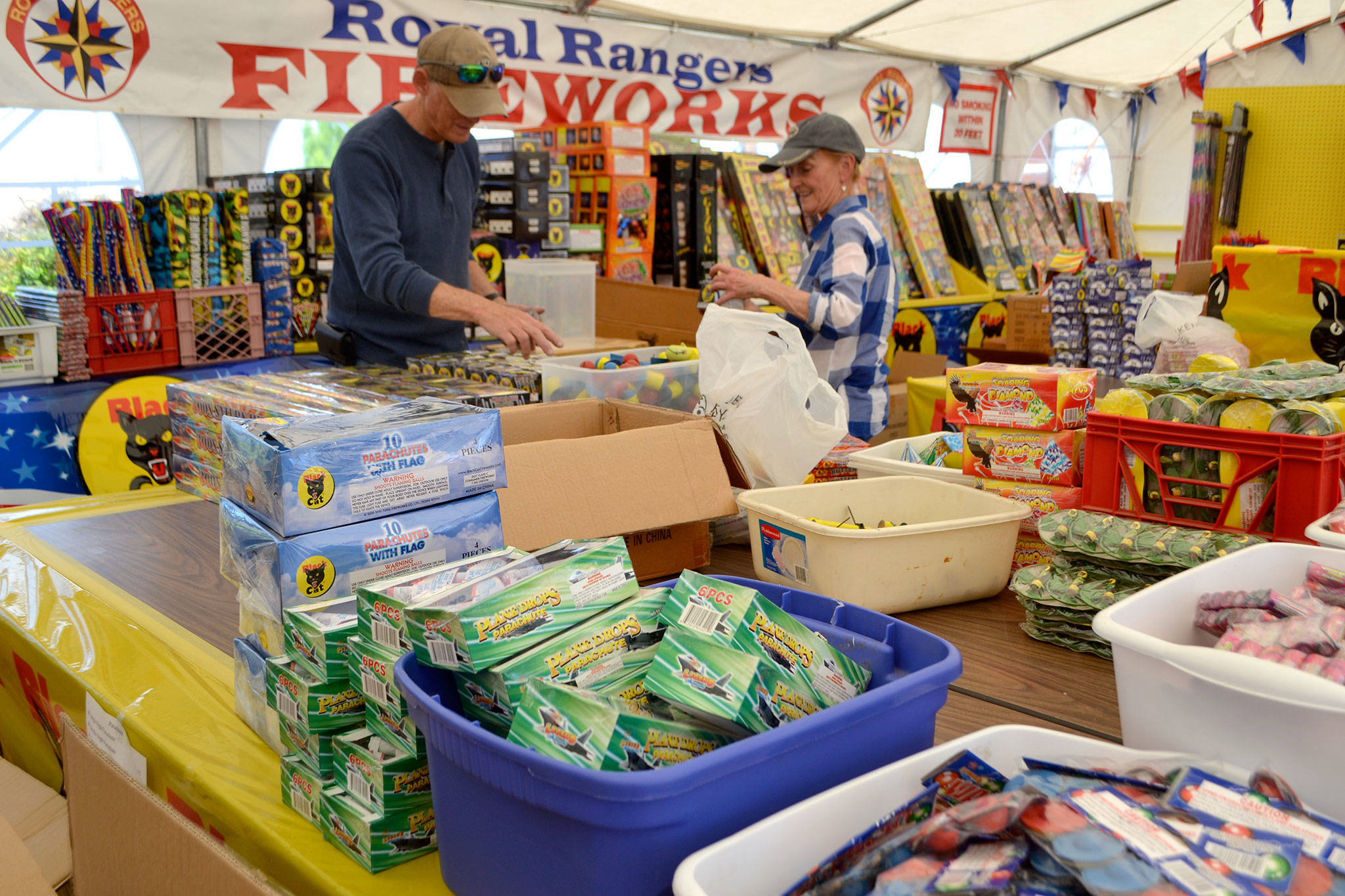 Terry and Sam Marsh, members of Sequim Worship Center, help set up the Royal Rangers fireworks booth on June 27 near Sequim JCPenney. It is one of four booths in Sequim city limits selling fireworks from June 28-July 5. Next year, the City of Sequim’s ban on discharing consumer fireworks is implemented but booth sales will continue. Sequim Gazette photo by Matthew Nash
