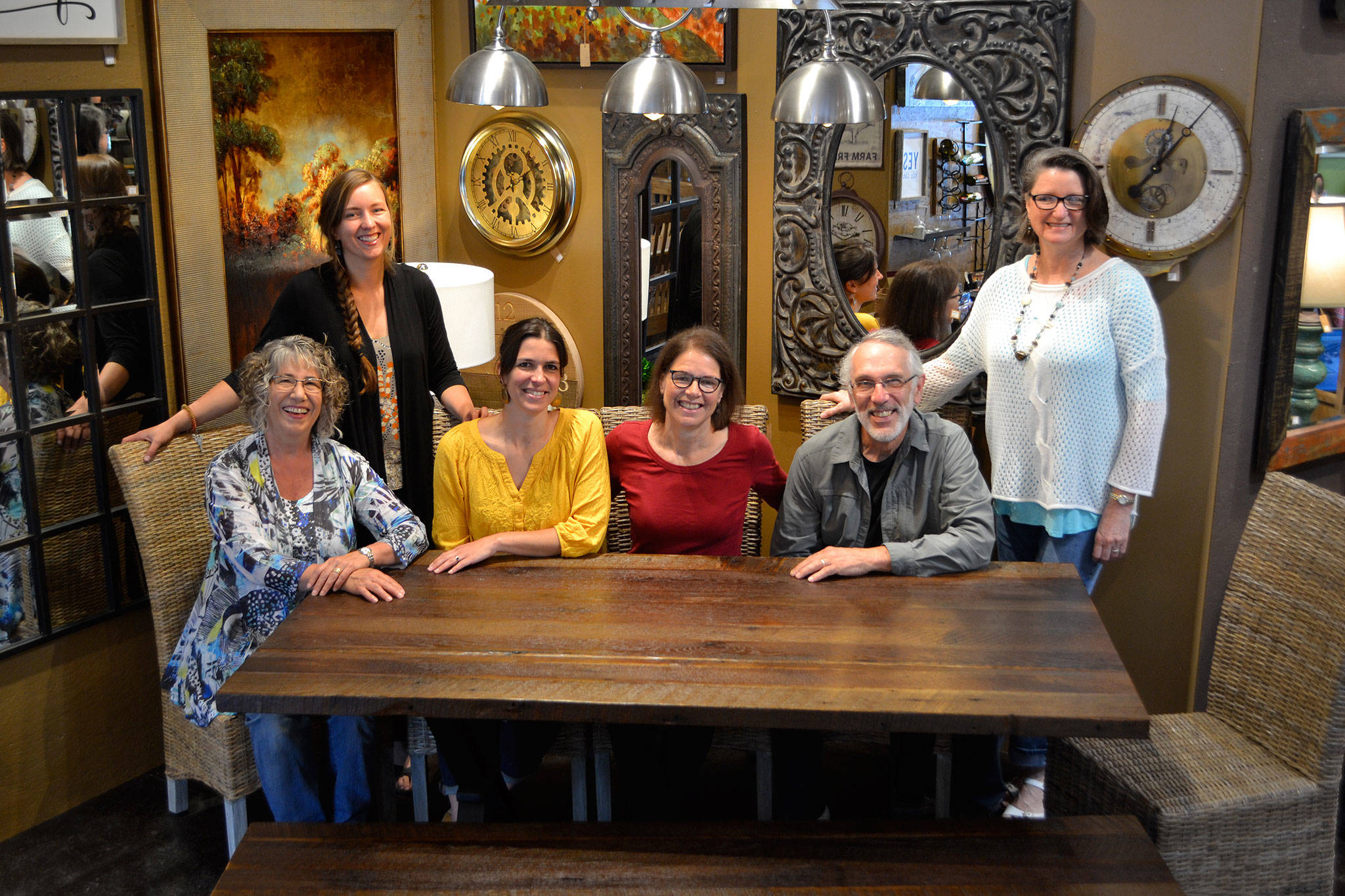 Jeri and Fran Sanford, fourth and fifth from left, recently listed their 20-year-old business Over the Fence for sale. They’ve offered home furnishings from around the world for more than 20 years. Staff for the store include, from left, Katy Nichols, Bergen Carey, Emily Underwood, Jeri and Fran Sanford, and Joanie May. Not pictured are Iris Edey, Cathy Lopes and Chris Biedermanngarde. Sequim Gazette photo by Matthew Nash