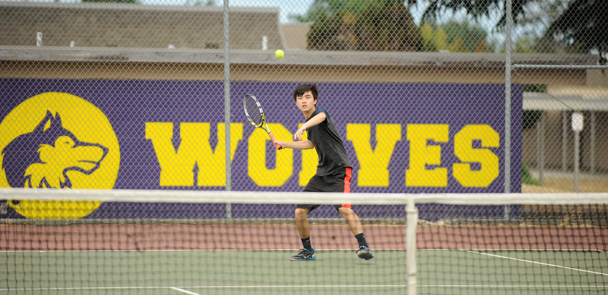 Raymond Lam returns a shot against Blake Wiker in the A Division finals on July 27. Wiker won in straight sets. Sequim Gazette photo by Michael Dashiell