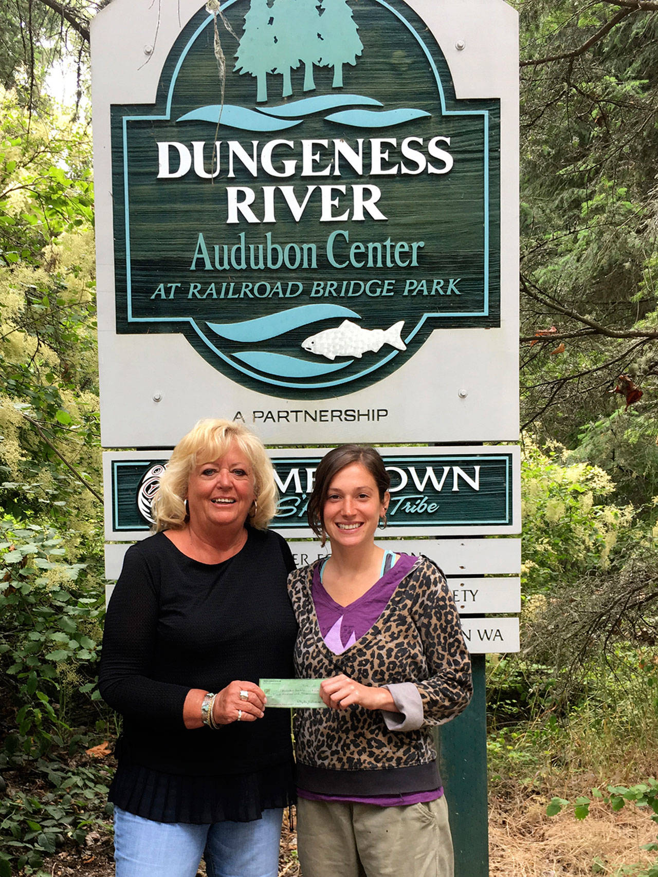 The Newcomers’ Club recently donated $200 to the Dungeness River Audubon Center in appreciation of its commitment to provide educational and environmental programs for adults and children. Jenna Ziogas, right, education and volunteer coordinator of the center, accepts the donation from Cathy Schau, Newcomers’ Club president. Submitted photo