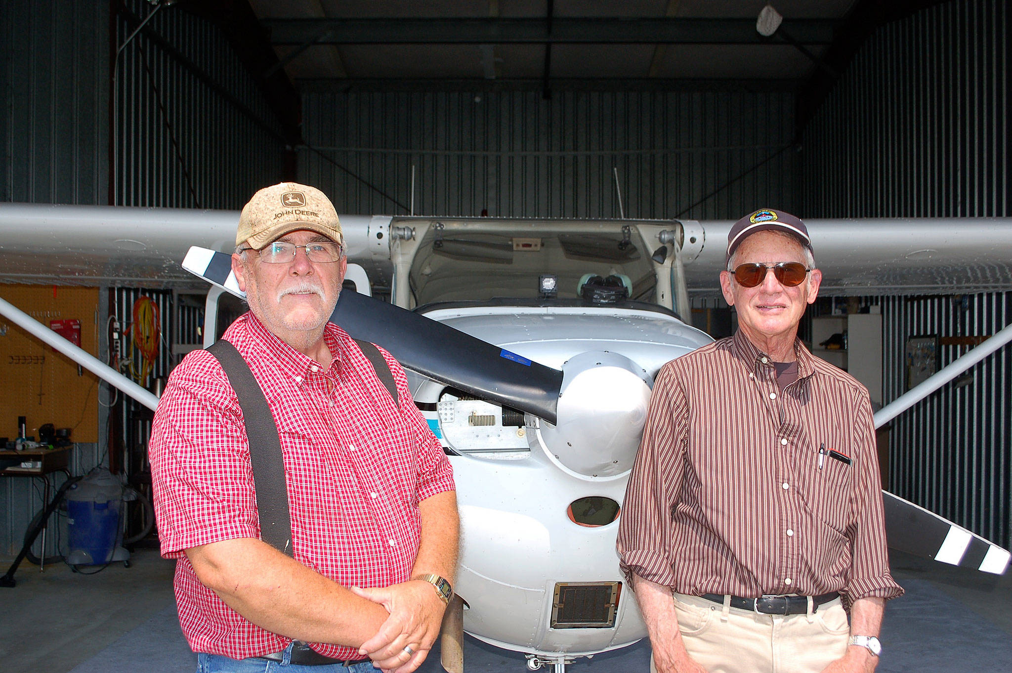 Sequim residents and airplane owners Dan Ramberg, left, and John Meyers stand in Ramberg’s airplane hangar at the Sequim Valley Airport. Ramberg and Meyers are both participating pilots for the Young Eagles Rally on Saturday, Aug. 12, giving free airplane rides to youth ages 8-17. Sequim Gazette photo by Erin Hawkins