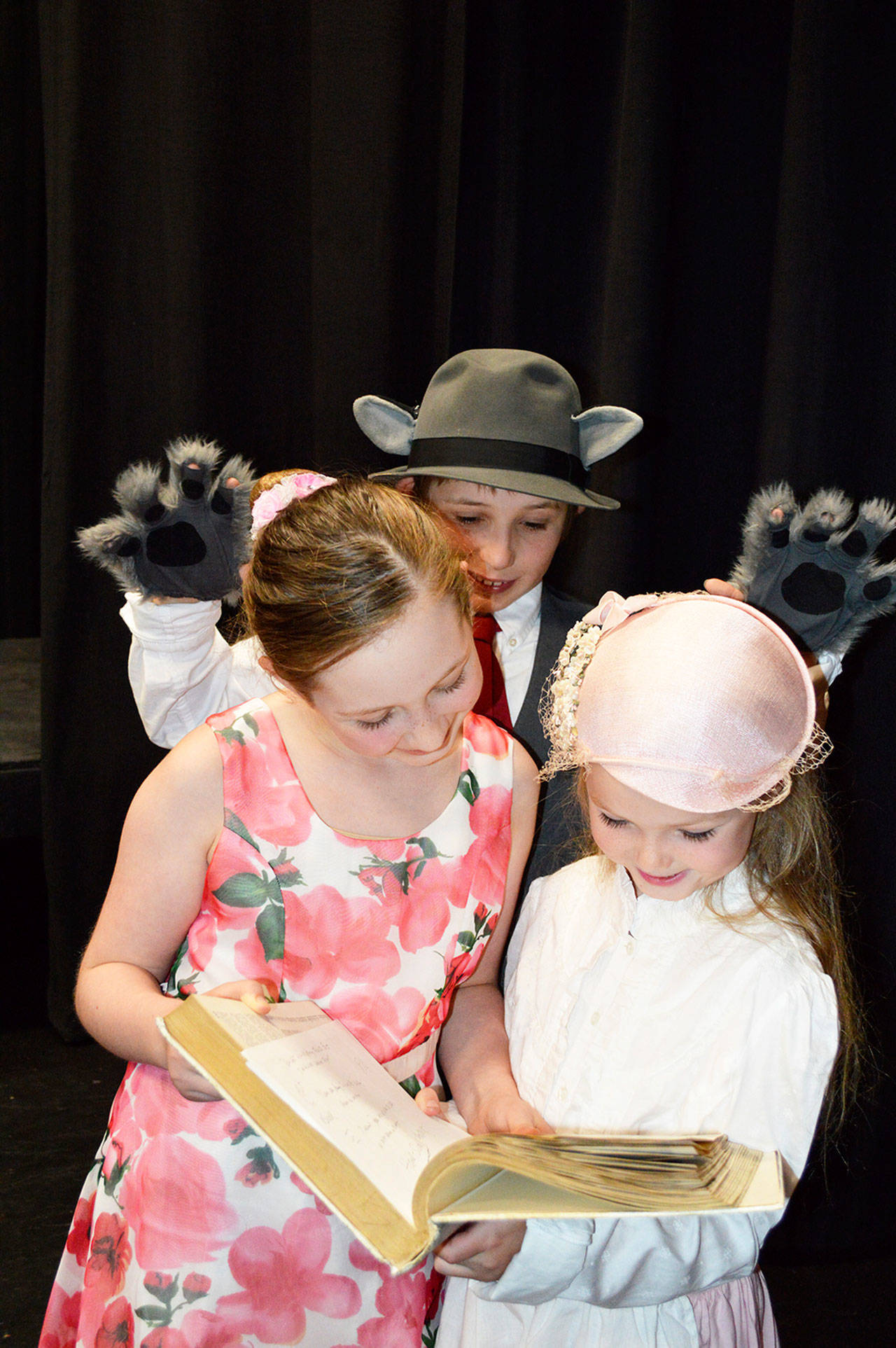 The Big Bad Wolf, played by Finn Waknitz, sneaks up on Miss Muffit played by Maria Burke, left, and Sarah Butterworth. Photo by Brandi Welch
