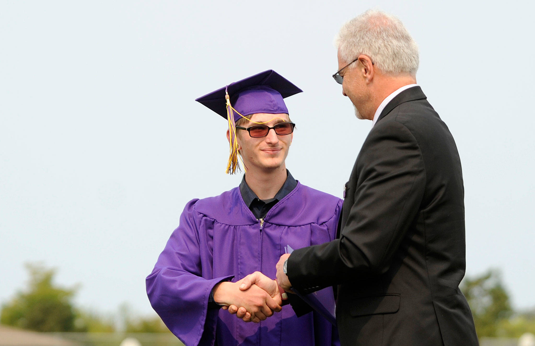 Michael Ray Barbour accepts his Sequim High School diploma from Sequim schools superintendent Gary Neal on Aug. 5. Sequim Gazette photo by Michael Dashiell