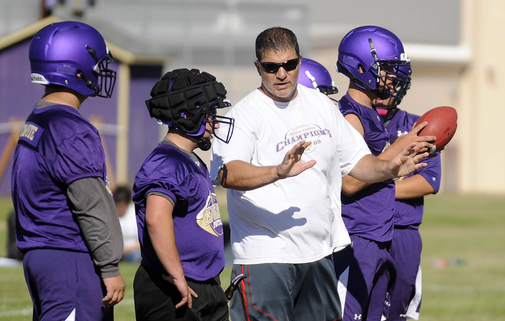 Sequim head coach Erik Wiker talks with players at Sequim High School’s first football practice on Aug. 16. The Wolves are scheduled to open their season Sept. 8 at Monetesano, after a Sept. 1 matchup against the Port Townsend Redhawks was canceled.