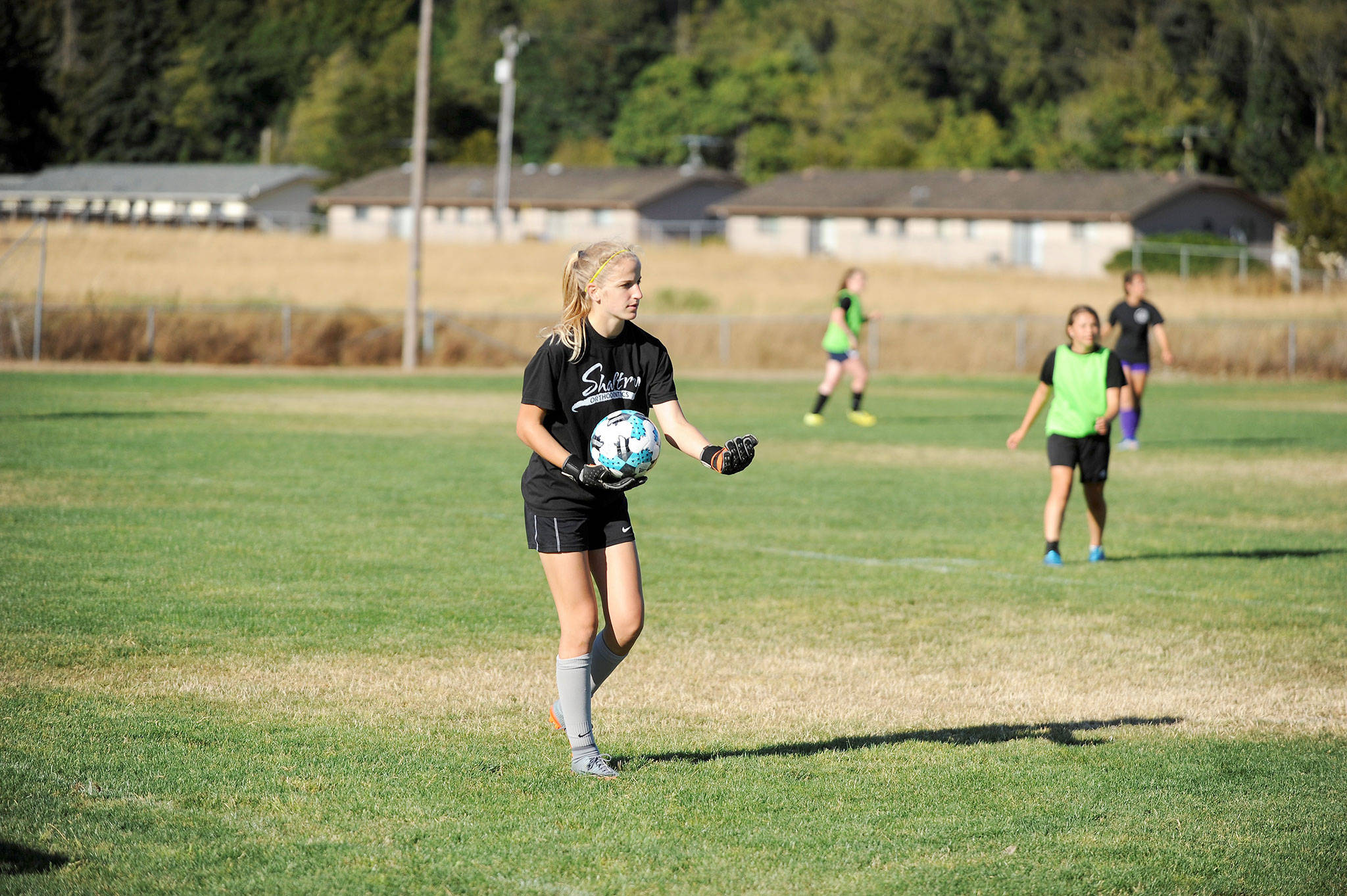 Sequim Goalkeeper Claire Henninger, a two-time, All-Olympic League first team player, looks to pass during a recent practice at the Albert Haller Playfields. She and other upperclassmen want to instill a strong work ethic in underclassmen this year. Sequim Gazette photo by Matthew Nash