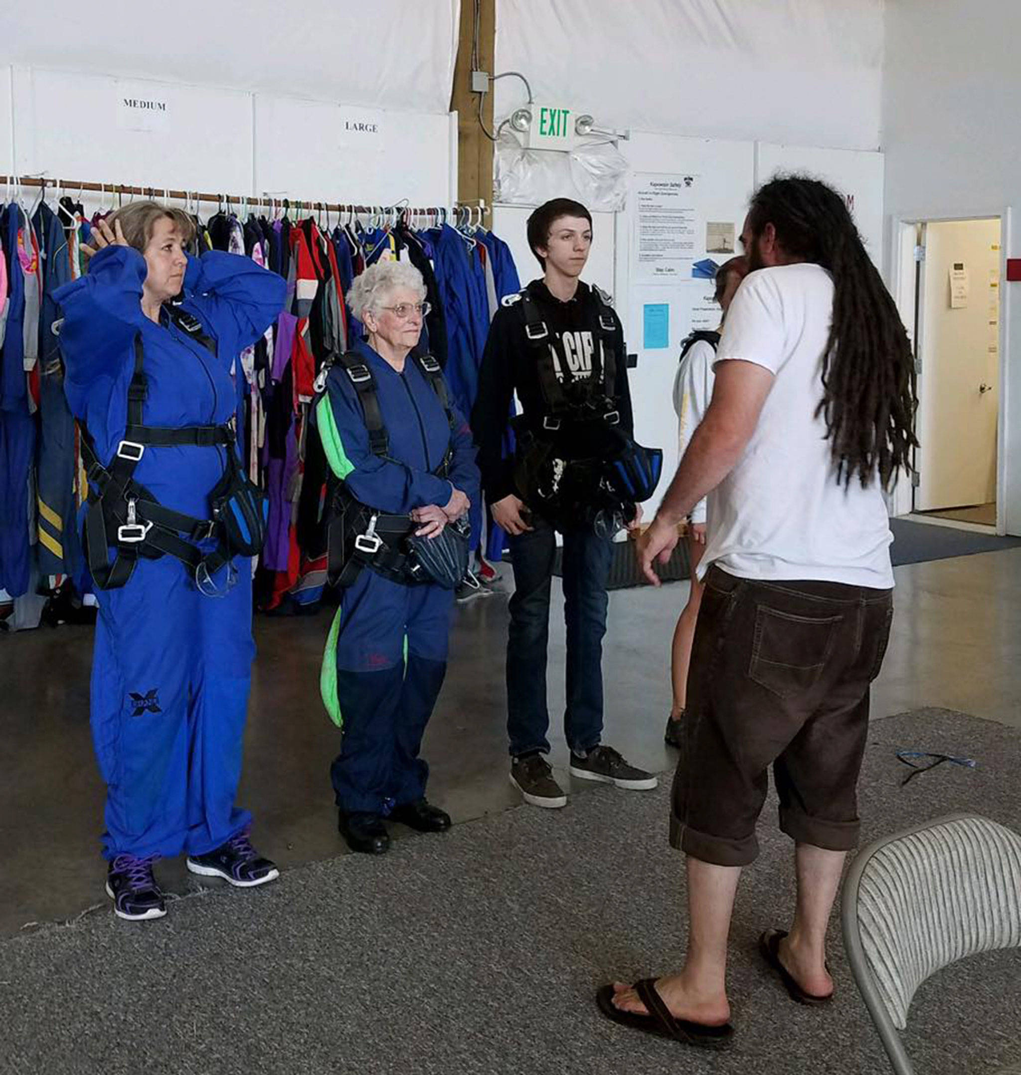 Family members, from left, Darcy Lamb, Clairee Meeks and Connor Lamb listen to an instructor with Skydive Kapowsin in Shelton on Aug. 25. The trio jumped together for the first time that day. It was Meeks’ sixth time. Photo courtesy of Clairee Meeks
