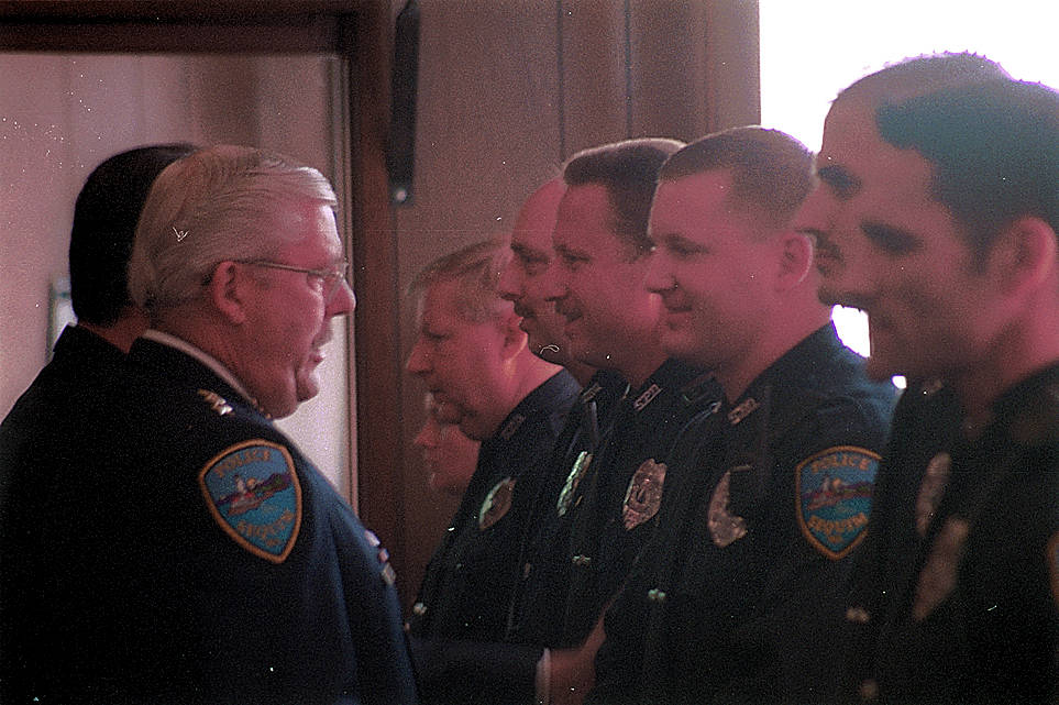 Outgoing police chief Byron Nelson, left, says goodbye to staff in a formal ceremony in 2002. Nelson died on Sept. 2. Sequim Gazette file photo