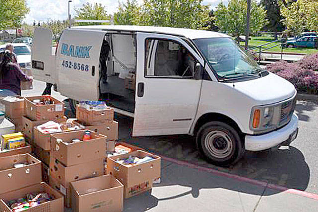 North Olympic Library System employees load a food bank van during the 2013 Food for Fines Program. Submitted photo