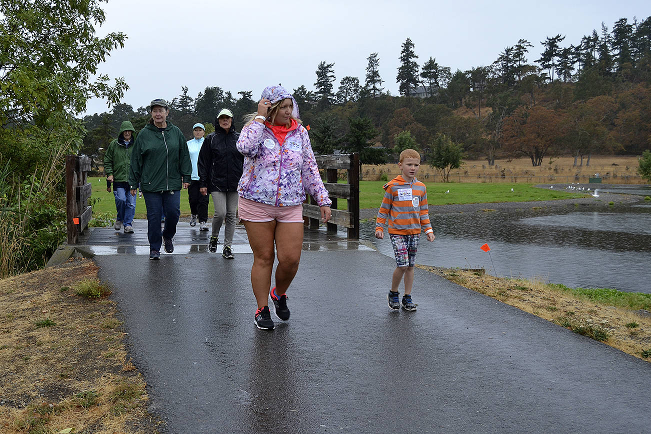 Vanessa Black and her 6-year-old son Chevy walk over the Water Reclamation Facility’s pond during the Dungeness Valley Health and Wellness Clinic’s Fun Walk on Sept. 9. Black, who works for Olympic Medical Center’s critical care unit, said she and her sons love to walk together and support others seeking healthy lifestyles. Sequim Gazette photo by Matthew Nash