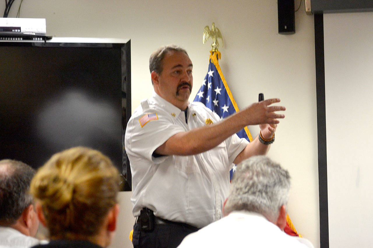 Fire Chief Ben Andrews for Clallam County Fire District 3 speaks about options whether or not fire commissioners accept a federal grant to help pay wages and benefits for six firefighters over three years. Andrews said the fire district will see expenses go higher than revenues tentatively in late 2018 if they accept the grant or not and that the fire district may need to turn to new revenue options such as an excess levy. Sequim Gazette photo by Matthew Nash