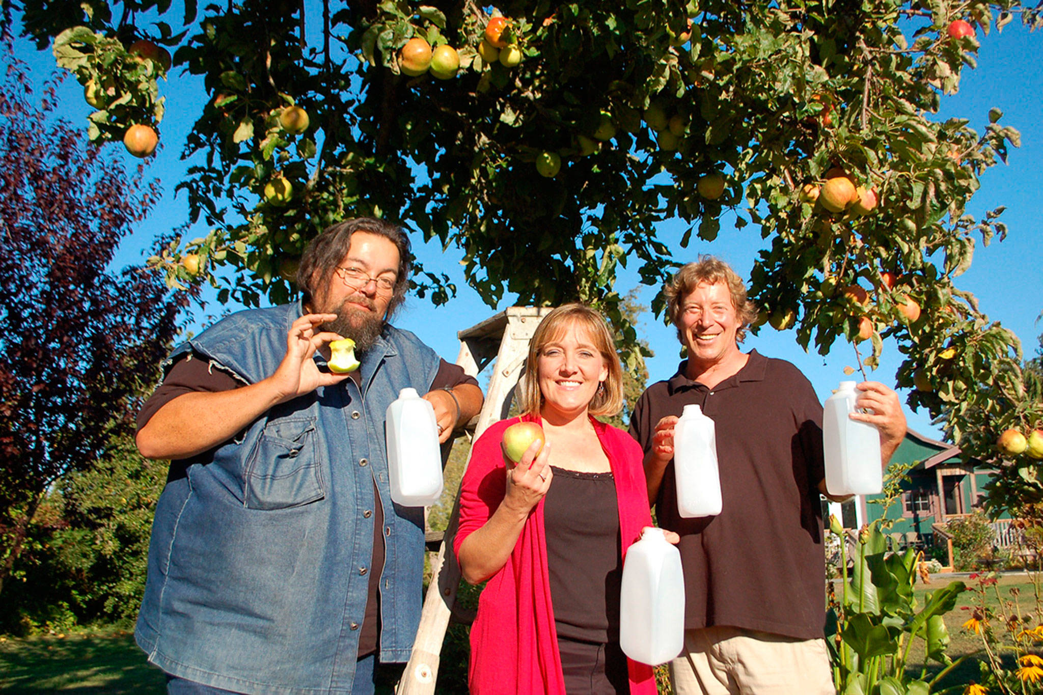 Coordinators of the eighth annual Apple Stock benefit, Jonathan Simonson, Kelly Sanders and Mark Schwartz prepare to press organic apples into cider from Oct. 6 through Oct. 8. The three-day event features music, cider pressing and concessions with donations going toward local causes. Sequim Gazette photo by Erin Hawkins