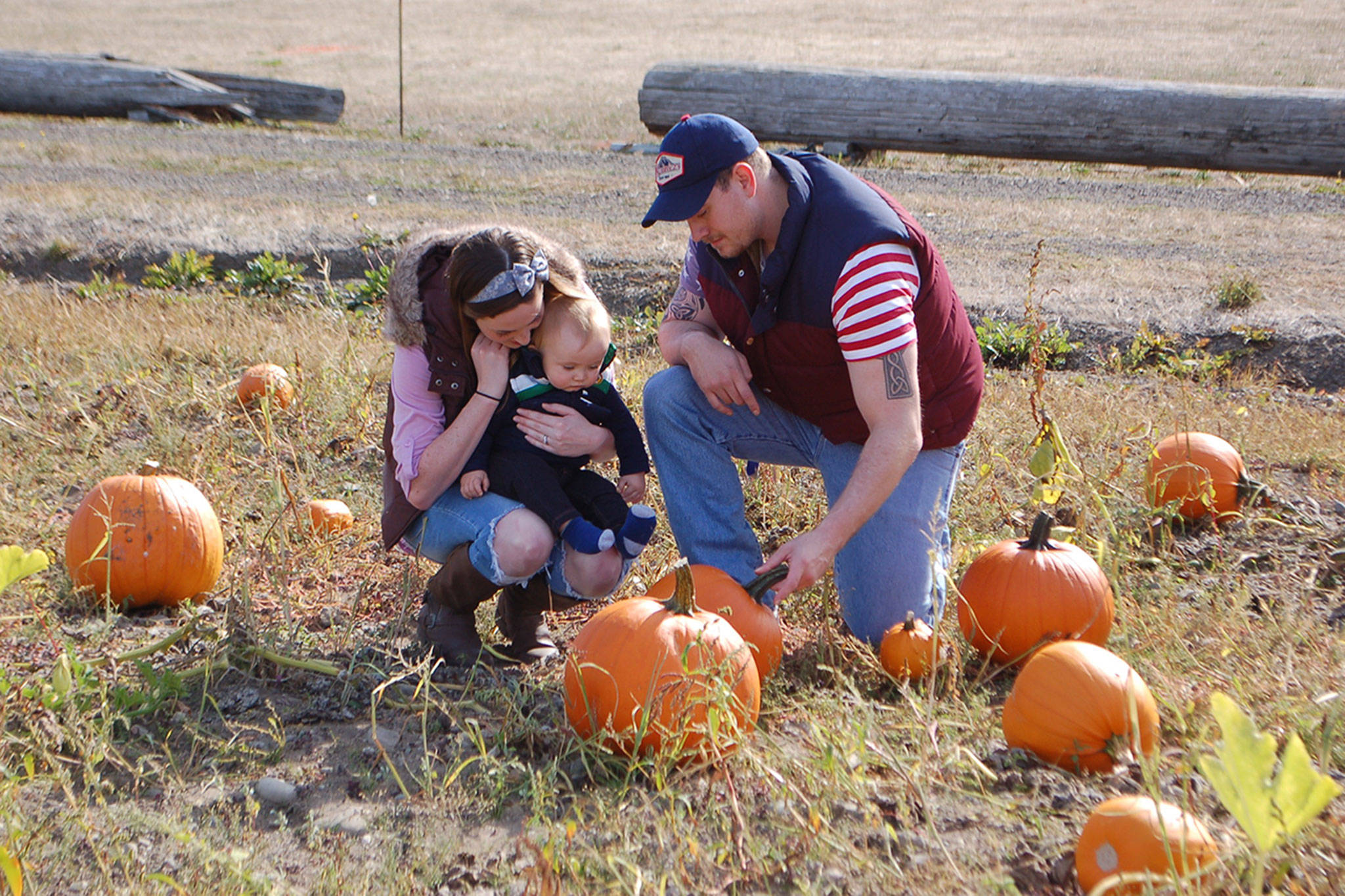 Last week, Danielle Brownell, Zachary Brownell and their 8-month-old son Grayson, of Forks, visit the Pumpkin Patch in Sequim for the first time. Sequim Gazette photo by Erin Hawkins