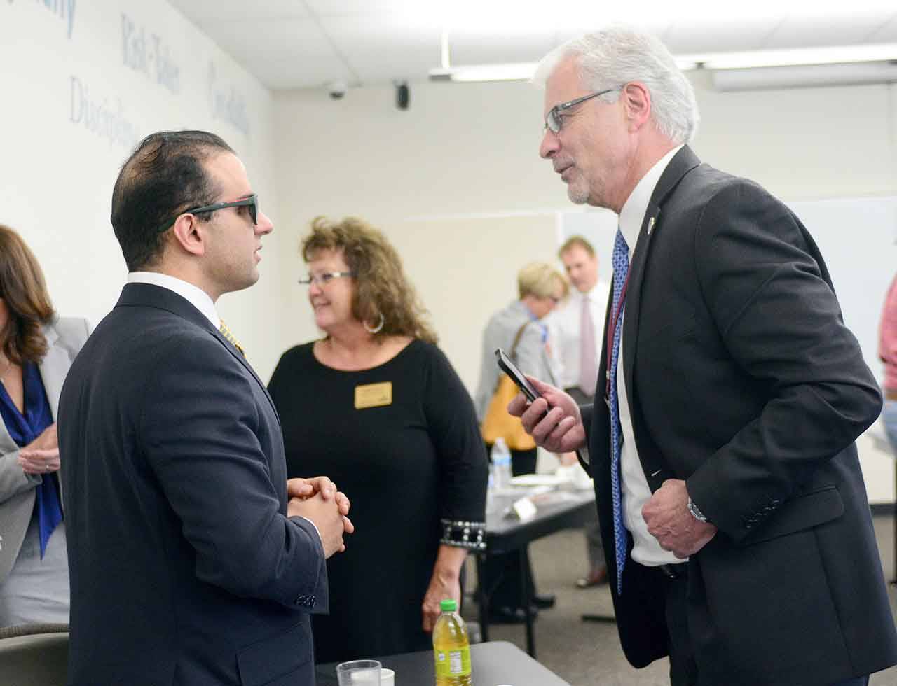 Lt. Gov. Cyrus Habib, left, chats with Sequim School District Superintendent Gary Neal on Wednesday. (Jesse Major/Peninsula Daily News)