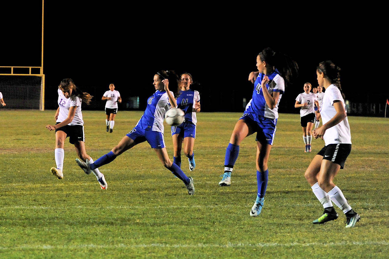 Sequim Forward Jessica Dietzman advances the ball towards teammate Hope Glasser near Olympic’s goal on Oct. 5. The Wolves lost 2-0 but maintained a spot for districts. Sequim Gazette photo by Matthew Nash
