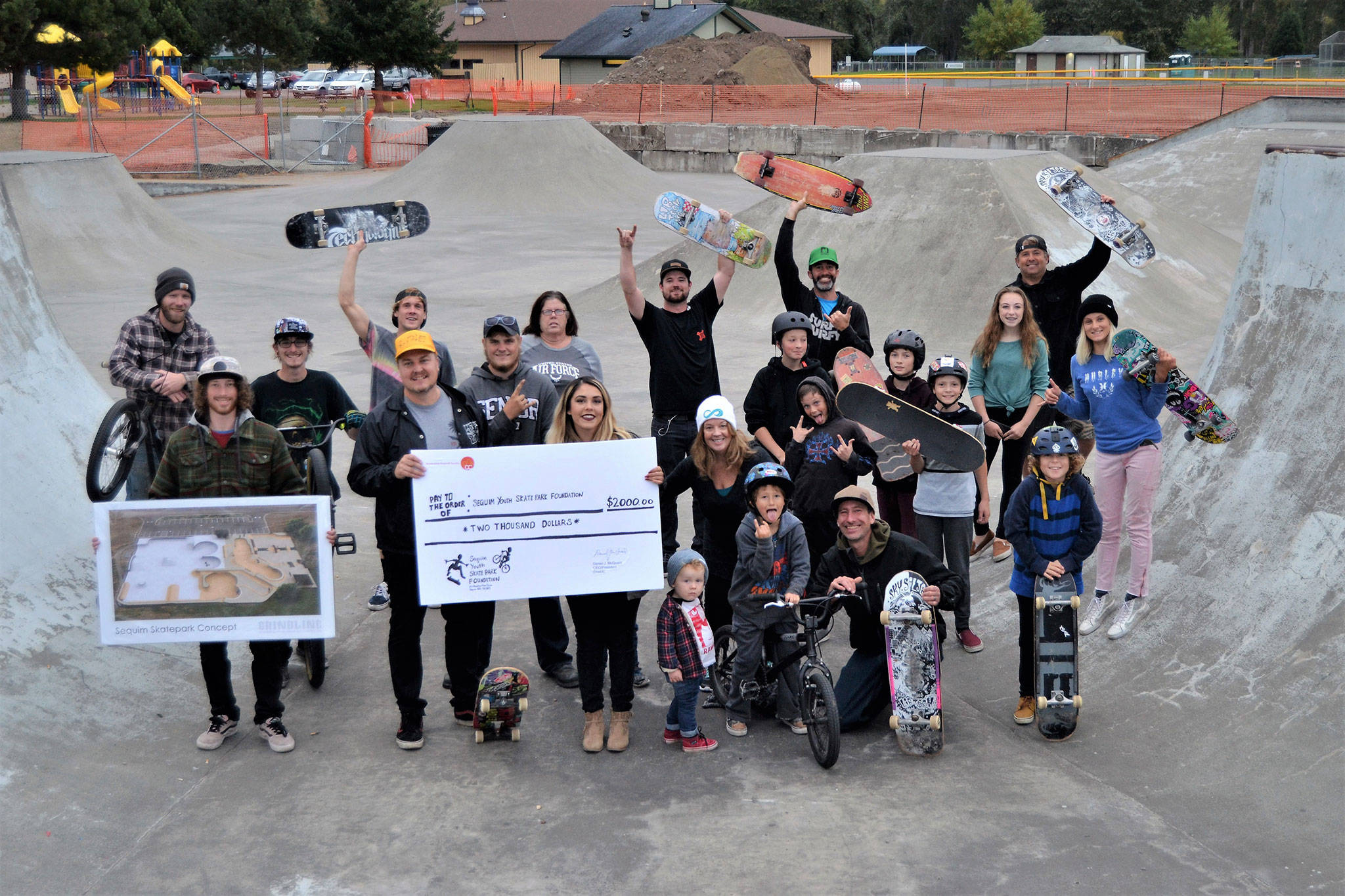 Local riders at Sequim Skate Park gather to accept a $2,000 check on Oct. 6 from the TeamInspire Project, founded by members of the band Emblem3. Funds will go towards a goal of expanding and fixing the exiting skate park. Sequim Gazette photo by Matthew Nash