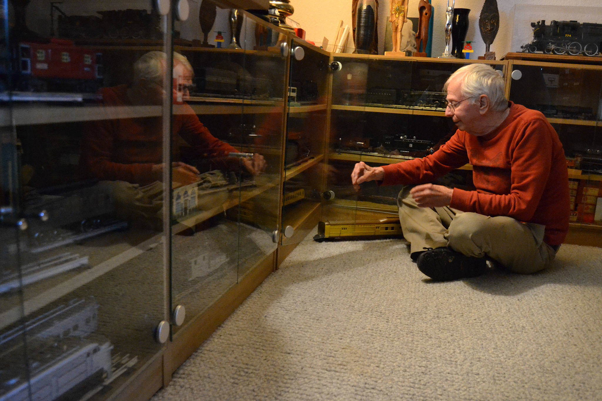 Pat Furey of Sequim sits with some of his train collection including a 1935 Lionel Union Pacific Passenger train. Furey said he grew up in New York and used to visit the big train displays at Christmas time and be “wowed.” Sequim Gazette photo by Matthew Nash