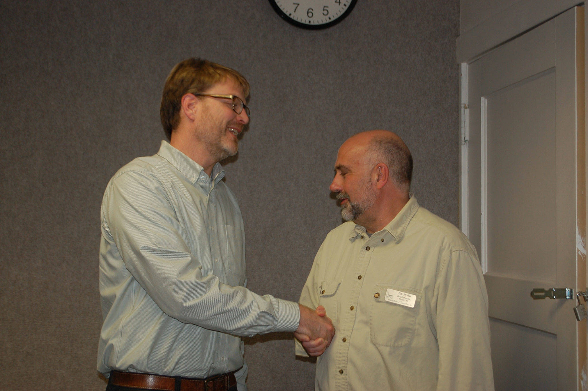 Sequim Education Association member and Sequim High School teacher Jon Eekhoff shakes hands with school board director Jim Stoffer after the board meeting on Oct. 16 where the board approved the collective bargaining agreement for Sequim teachers. Sequim Gazette photo by Erin Hawkins