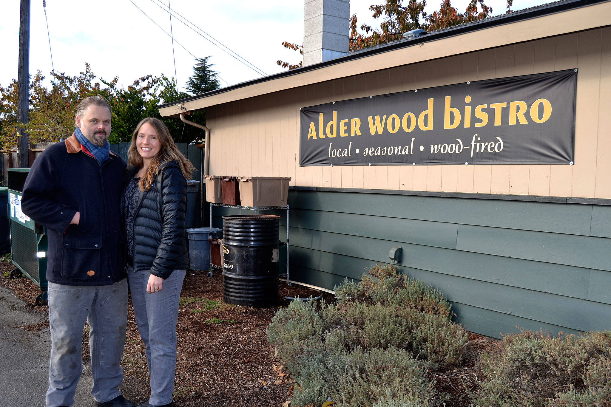 Gabriel and Jessica Schuenemann, owners of Alder Wood Bistro, stand by their business’ recycling area where they seek to significantly reduce their landfill contribution. The business only has one 96-gallon trash can and all food waste is composted. Sequim Gazette photos by Matthew Nash