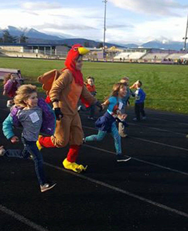 Principal Becky Stanton runs with students at last year’s Turkey Trot benefiting Helen Haller Elementary. This year, the event runs on Nov. 22 with students seeking donations to support new books and a robotics program. Submitted photo
