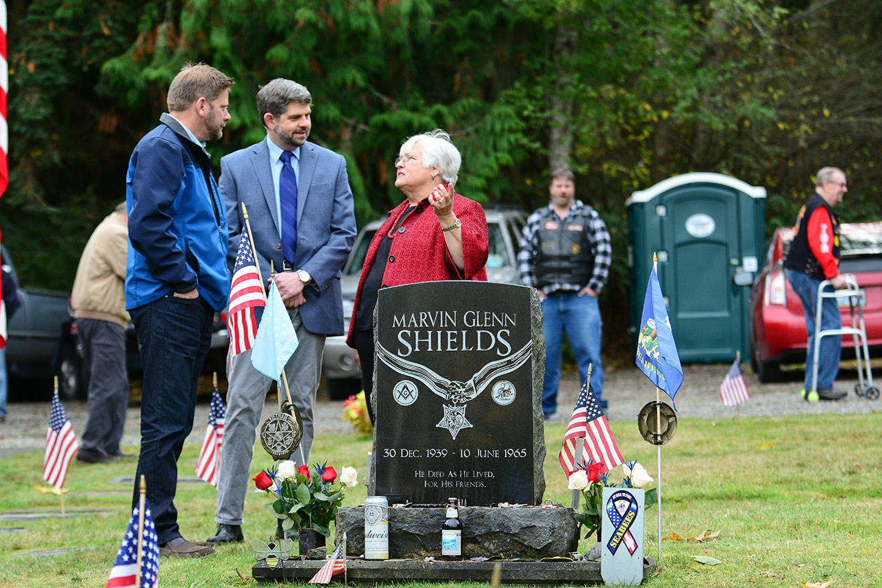 State Rep. Mike Chapman, D-Port Angeles, left, and Clallam County Commissioner Mark Ozias talk with Joan Shields-Bennett before a Sojourner memorial service honoring her late husband, Marvin G. Shields, on Saturday. (Jesse Major/Peninsula Daily News)