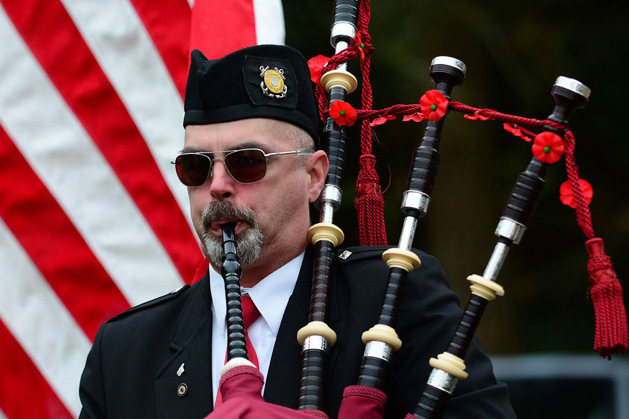 Rick McKenzie, a retired Coast Guard veteran, plays bagpipes during the Sojourners memorial service for Marvin G. Shields on Saturday. (Jesse Major/Peninsula Daily News)