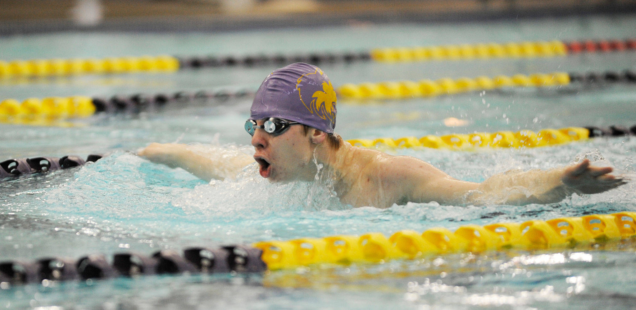 Alex Berikoff swims the butterfly at a meet last season. He’s one of four returners from last year but the team now boasts 20 swimmers. Sequim Gazette file photo by Michael Dashiell