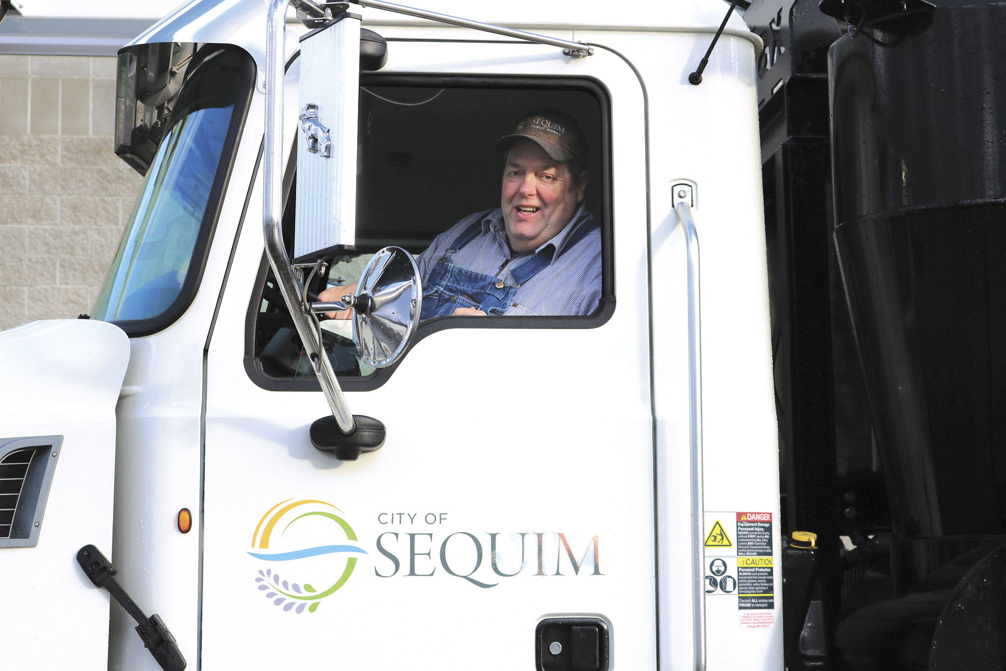 Clint Rushton of the Sequim Public Works Department smiles from the cab of a city truck. Submitted photo