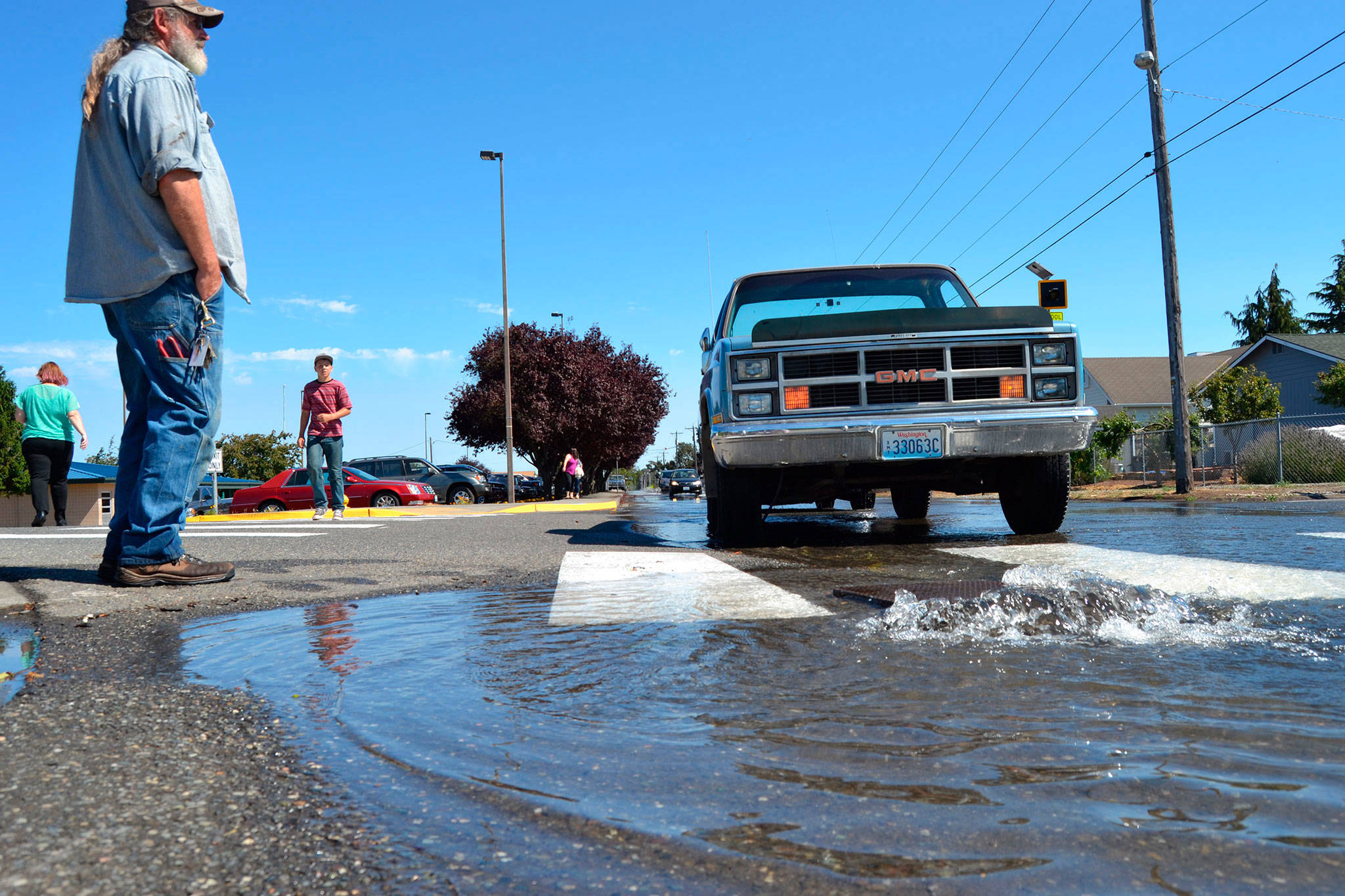 Construction on Fir Street by Sequim schools could start as soon as July 2018, say city staff, to repair water, sewer and irrigation lines, which should solve flooding issues like this scene in late August. Sequim Gazette file photo by Matthew Nash