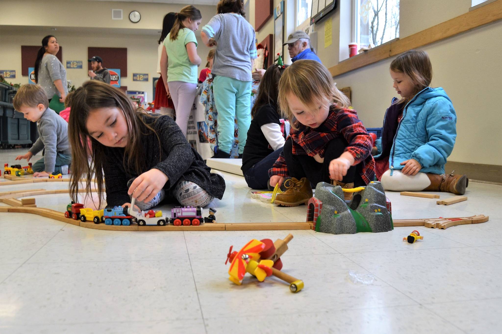 Alivia, 5, and Aria Cummings, 2, of Sequim play trains donated by the North Olympic Peninsula Railroaders at the annual Breakfast with Santa on Dec. 2. This year was the first time the sisters attended the event. Sequim Gazette photo by Matthew Nash